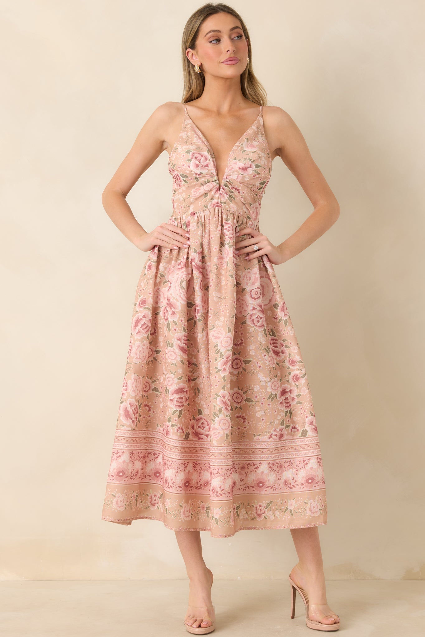 Beige and pink floral midi dress with a deep V-neckline and softly flowing silhouette.