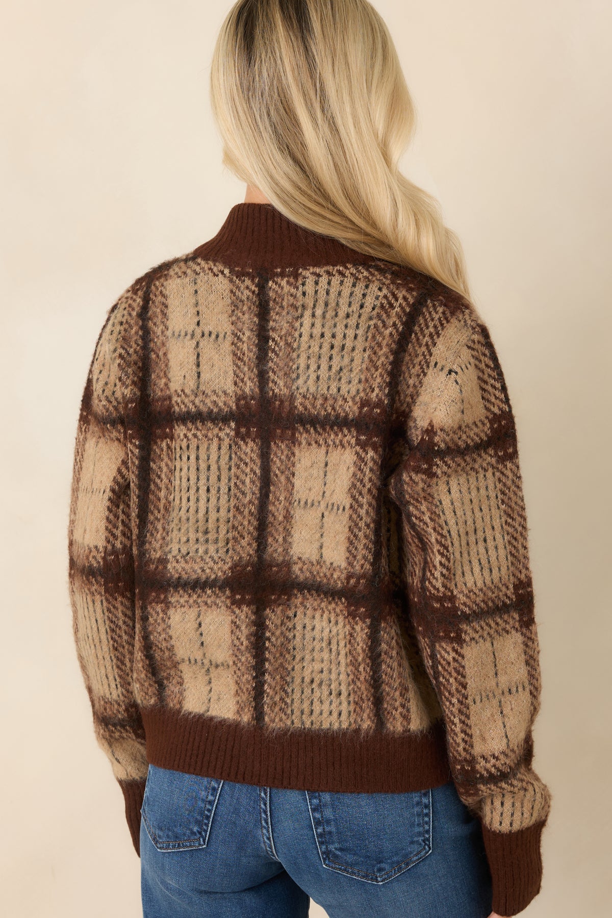 Rear of the beige and brown plaid cardigan showcasing its checked knit pattern, relaxed shape, and ribbed hem.