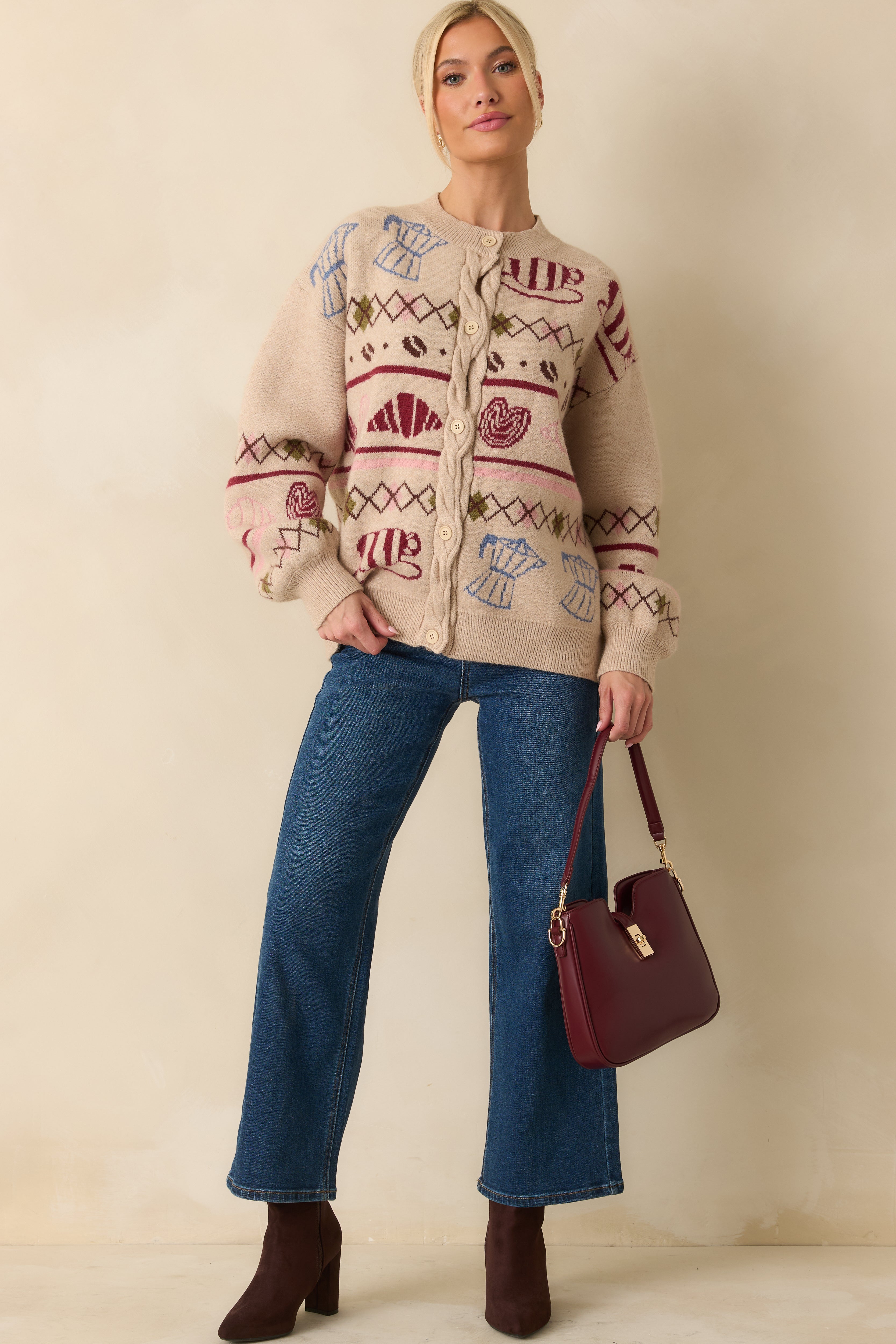 Beige cardigan with a cable-knit placket and front buttons, showcasing its charming patterned design.
