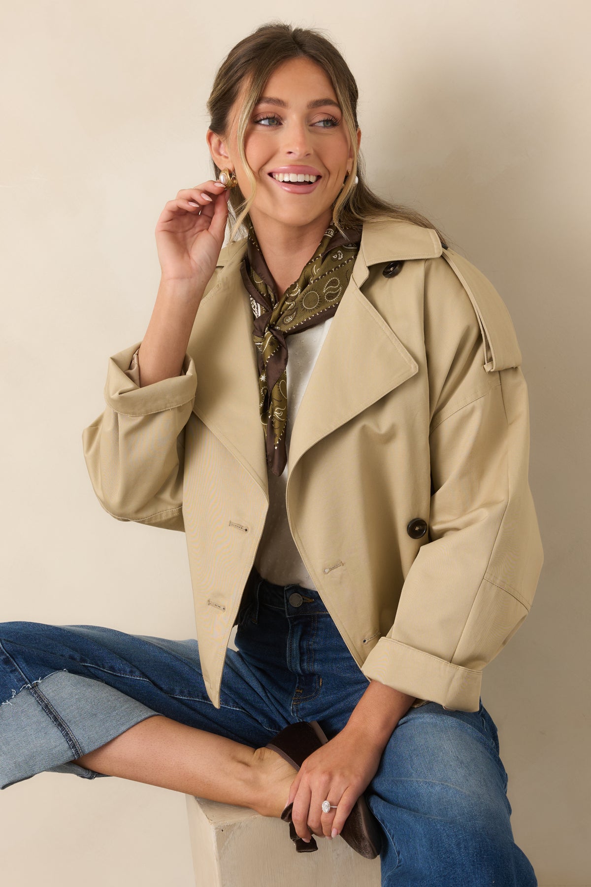 Tonal buttons and a notched lapel give the beige jacket a classic double-breasted trench-inspired finish.