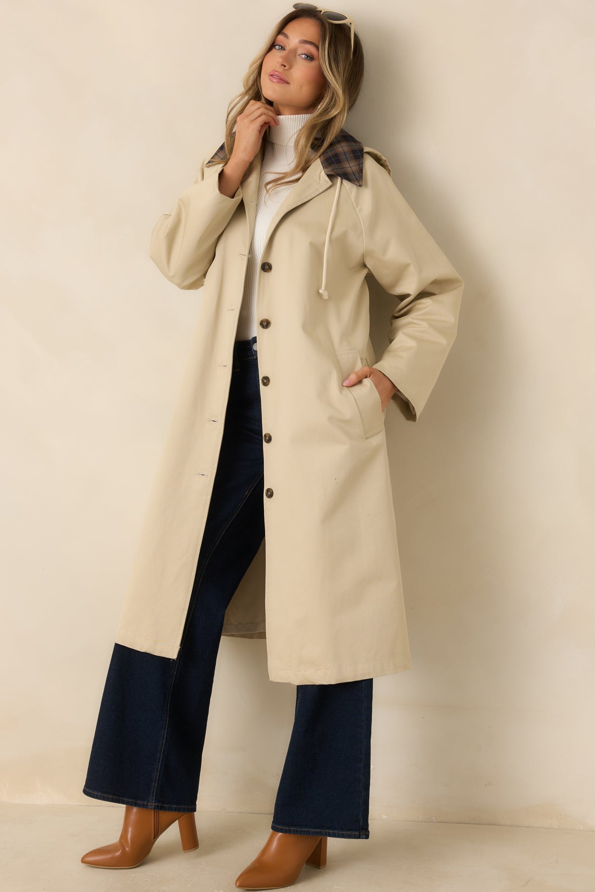 Beige cotton coat with a drawstring hood, contrasting plaid collar, button front, and long raglan sleeves.