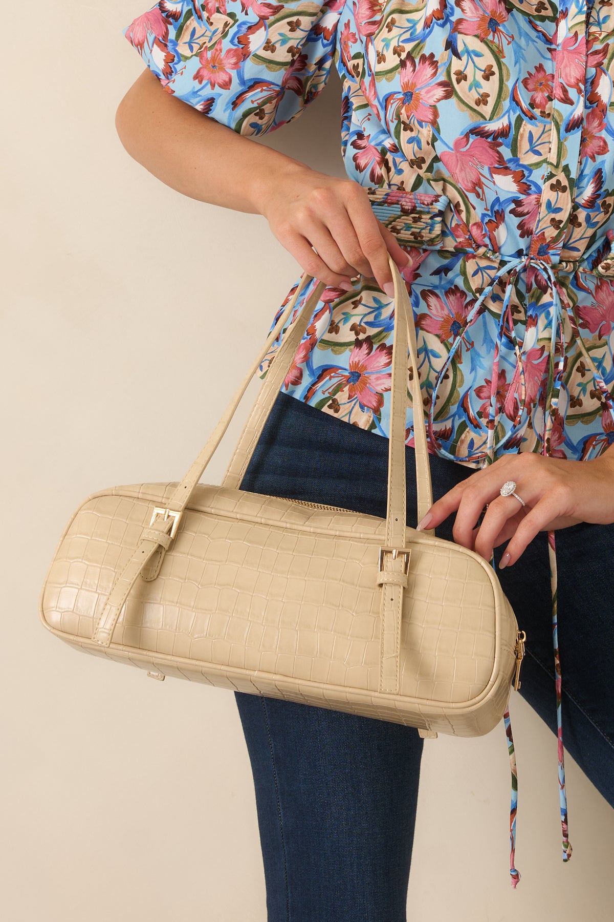 Beige faux crocodile leather handbag with structured top handles, a single compartment, and sleek zipper closure.