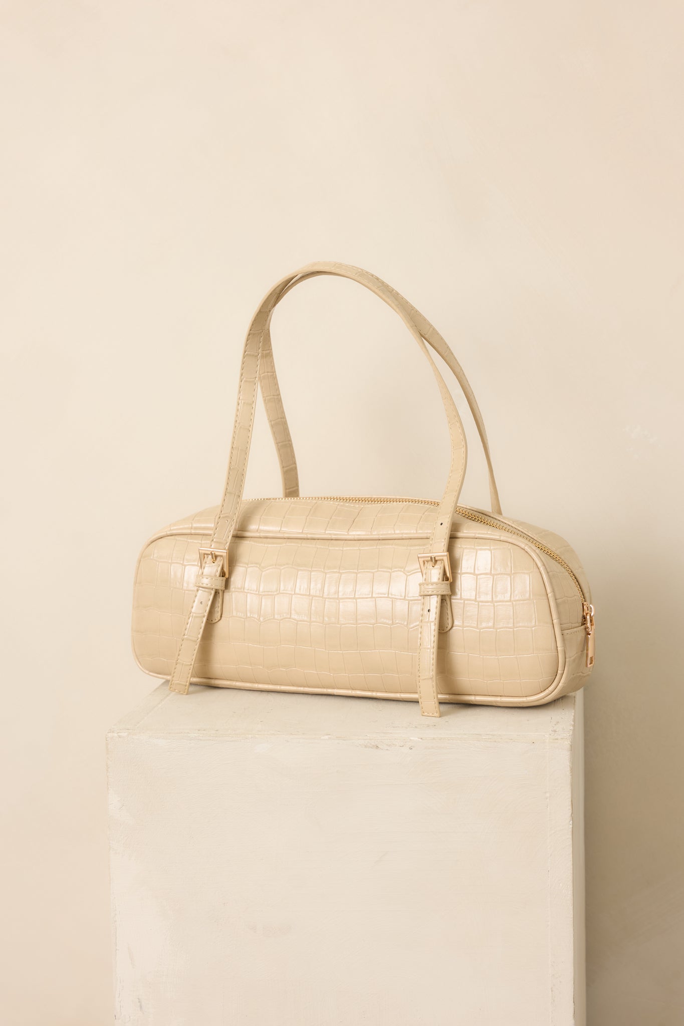 Beige faux crocodile handbag highlighting the raised textured finish, structured top handles, and clean rectangular shape.