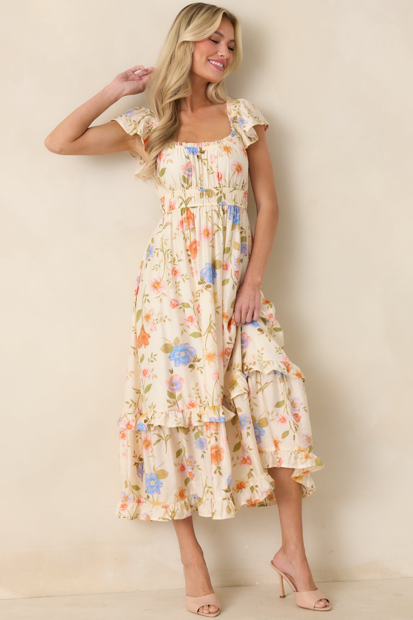 Beige floral midi dress with flutter sleeves and a relaxed, airy silhouette.