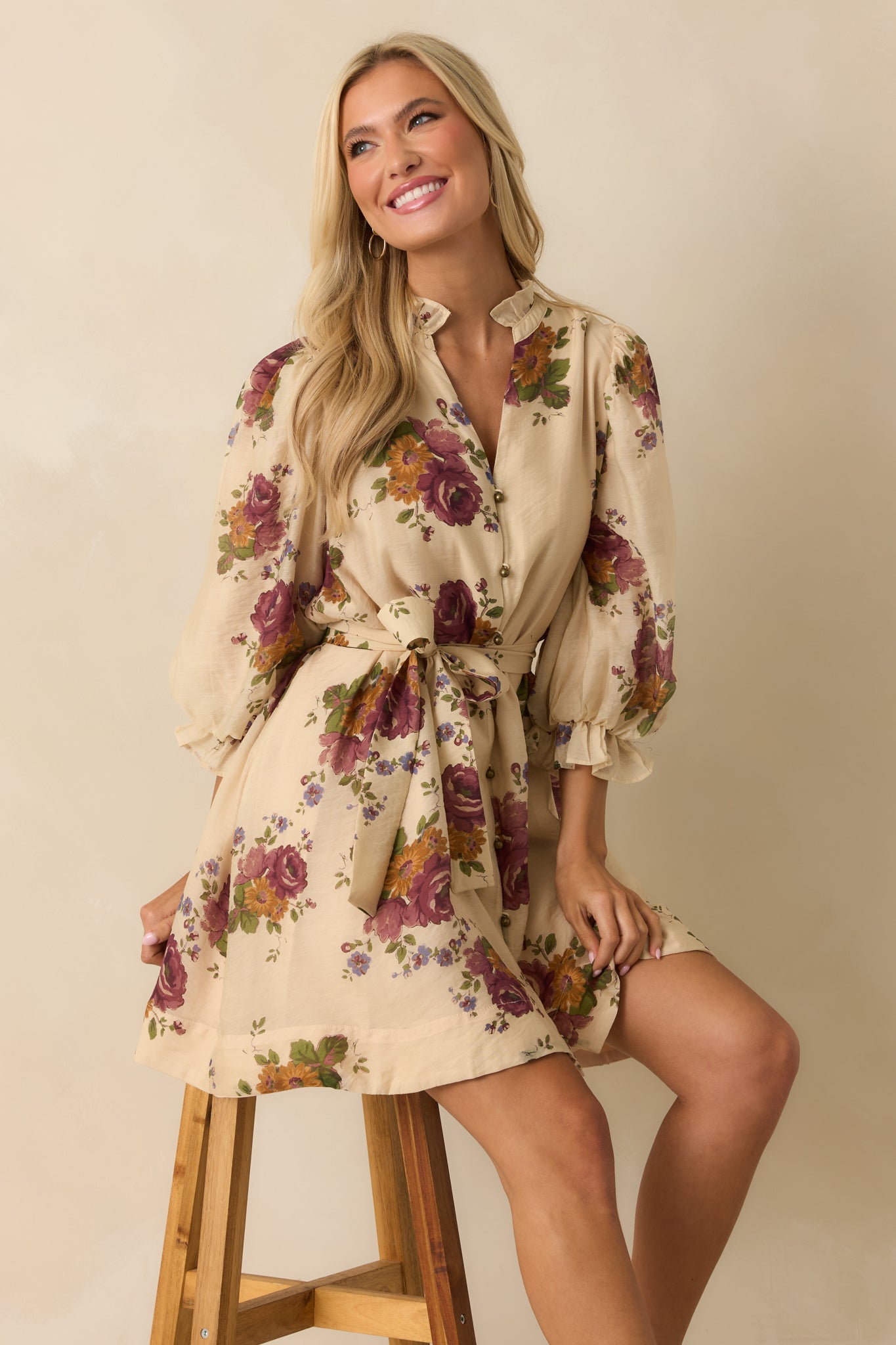 Floral mini dress in beige featuring puff sleeves, ruffled cuffs, and a relaxed silhouette.