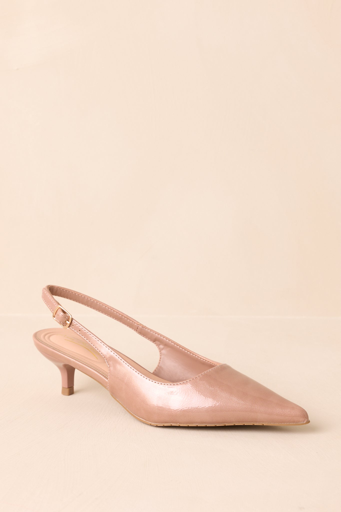 Angled view of the beige heels showing both the slingback strap and pointed toe.