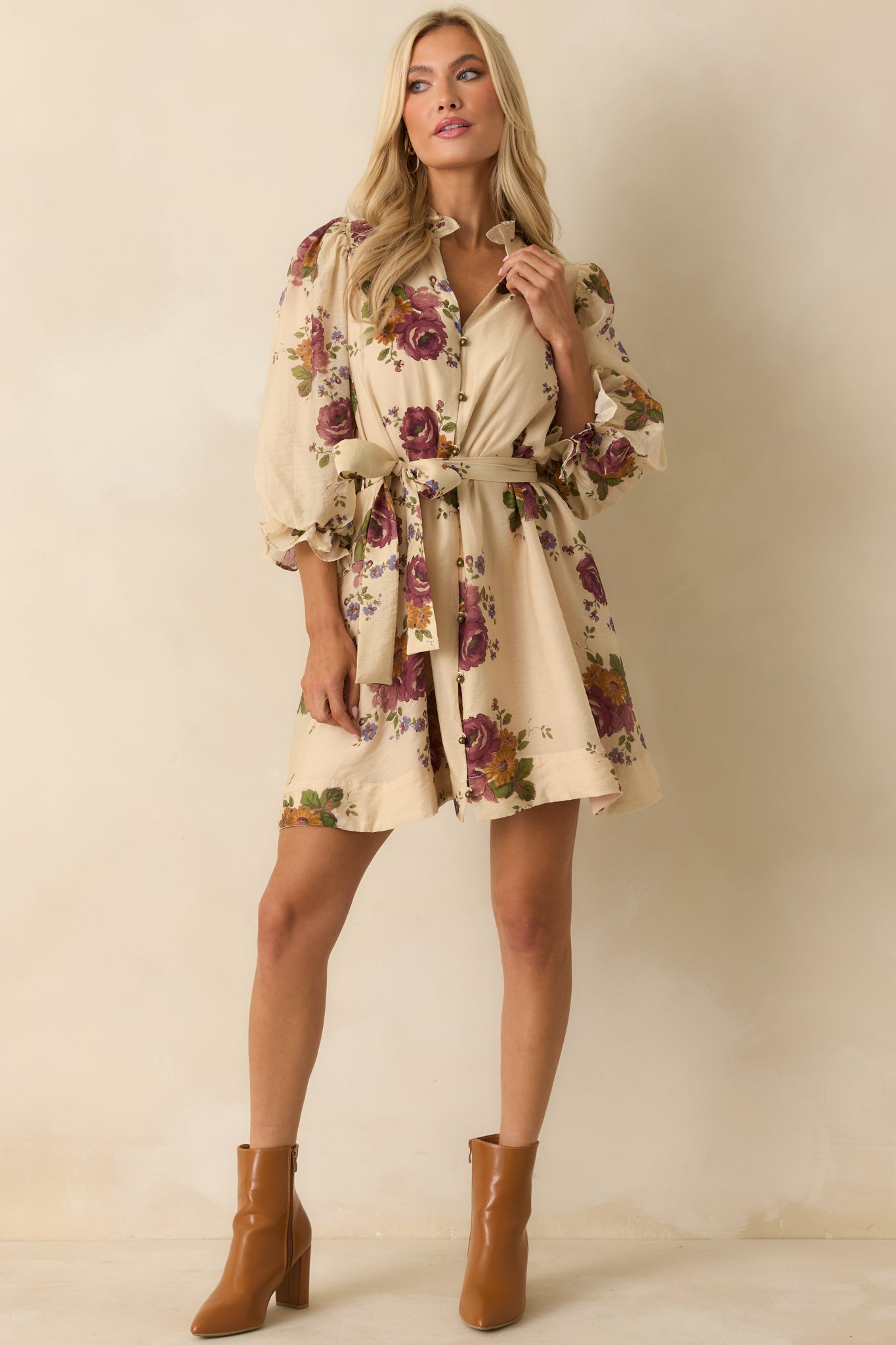 Beige mini dress with button-down front, collared neckline, and adjustable waist tie for shape.