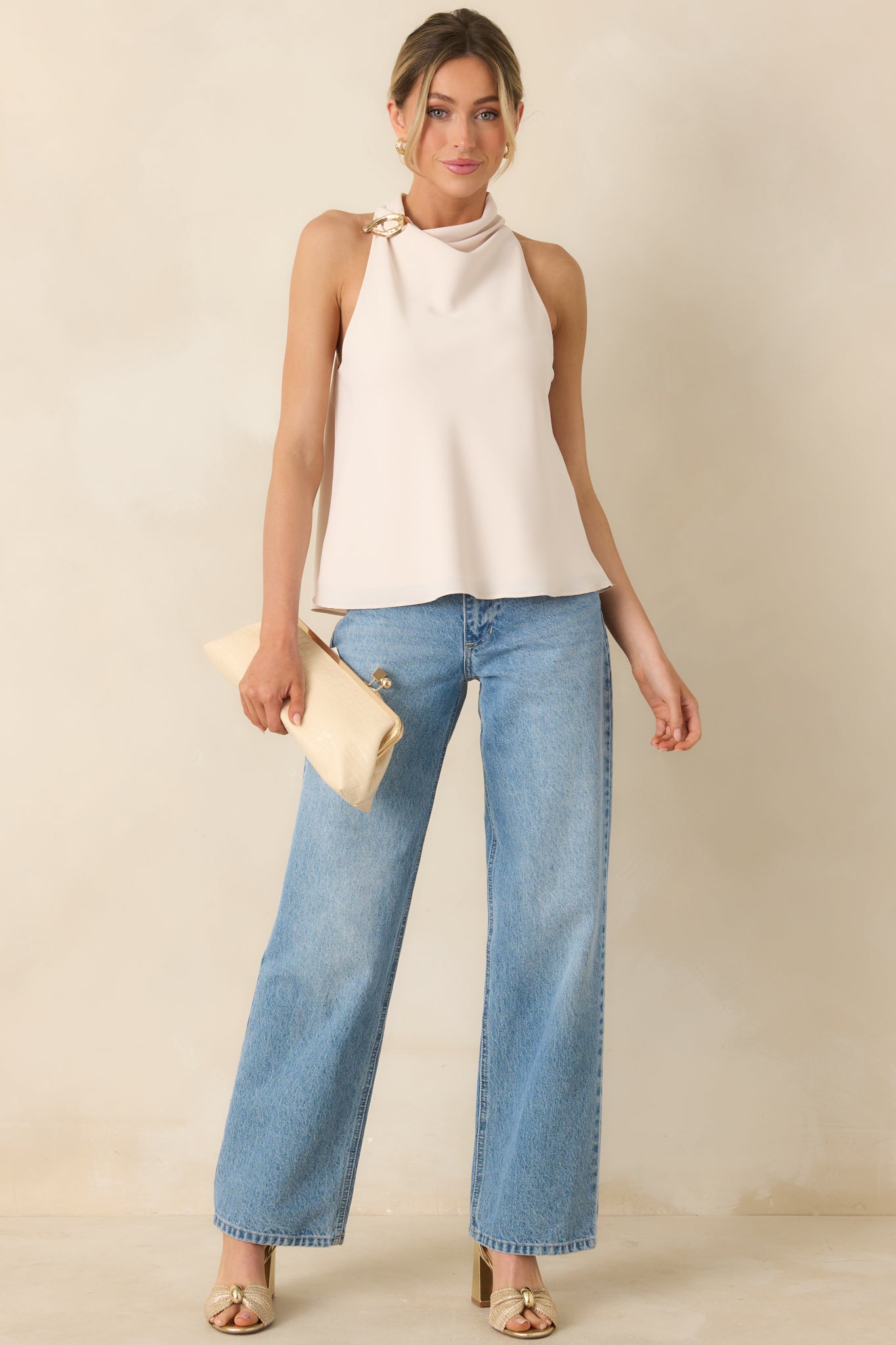 Beige sleeveless top with soft draping and gold-tone shoulder detail.
