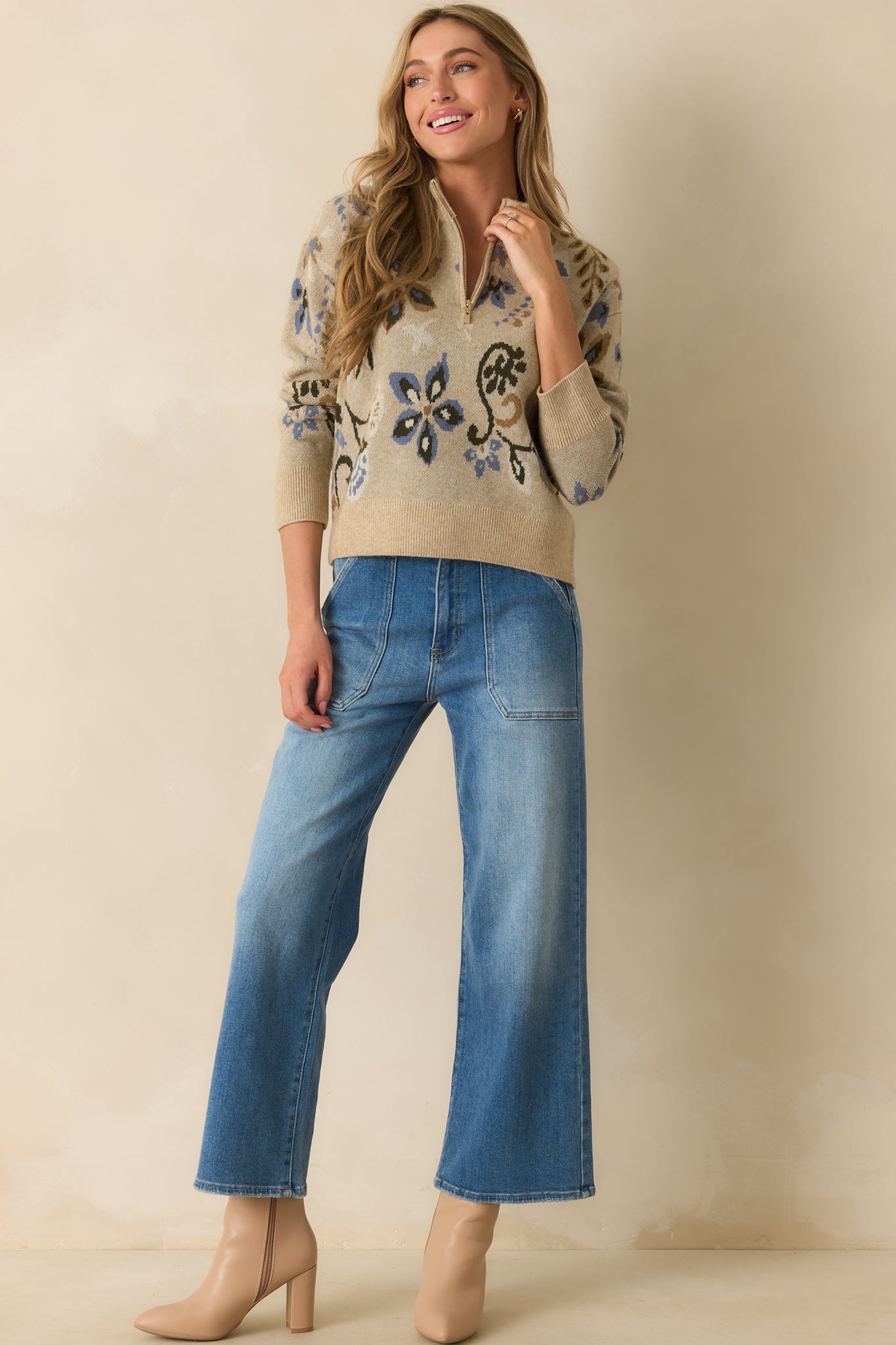 Beige floral sweater with half-zip closure, ribbed cuffs, and long sleeves.