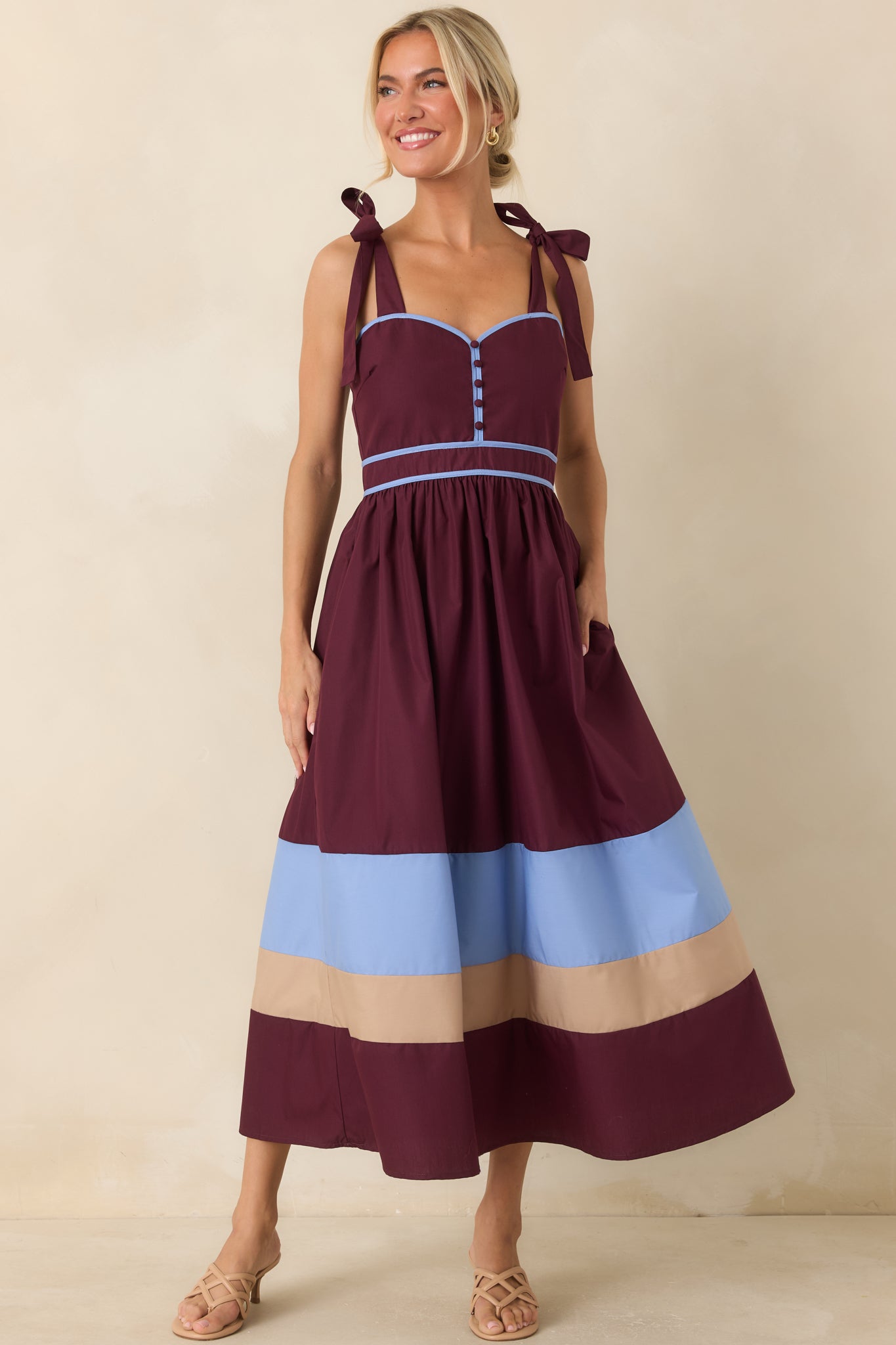 Berry and blue color-blocked dress with a flattering fitted bodice, gathered skirt, and playful vacation-ready style.