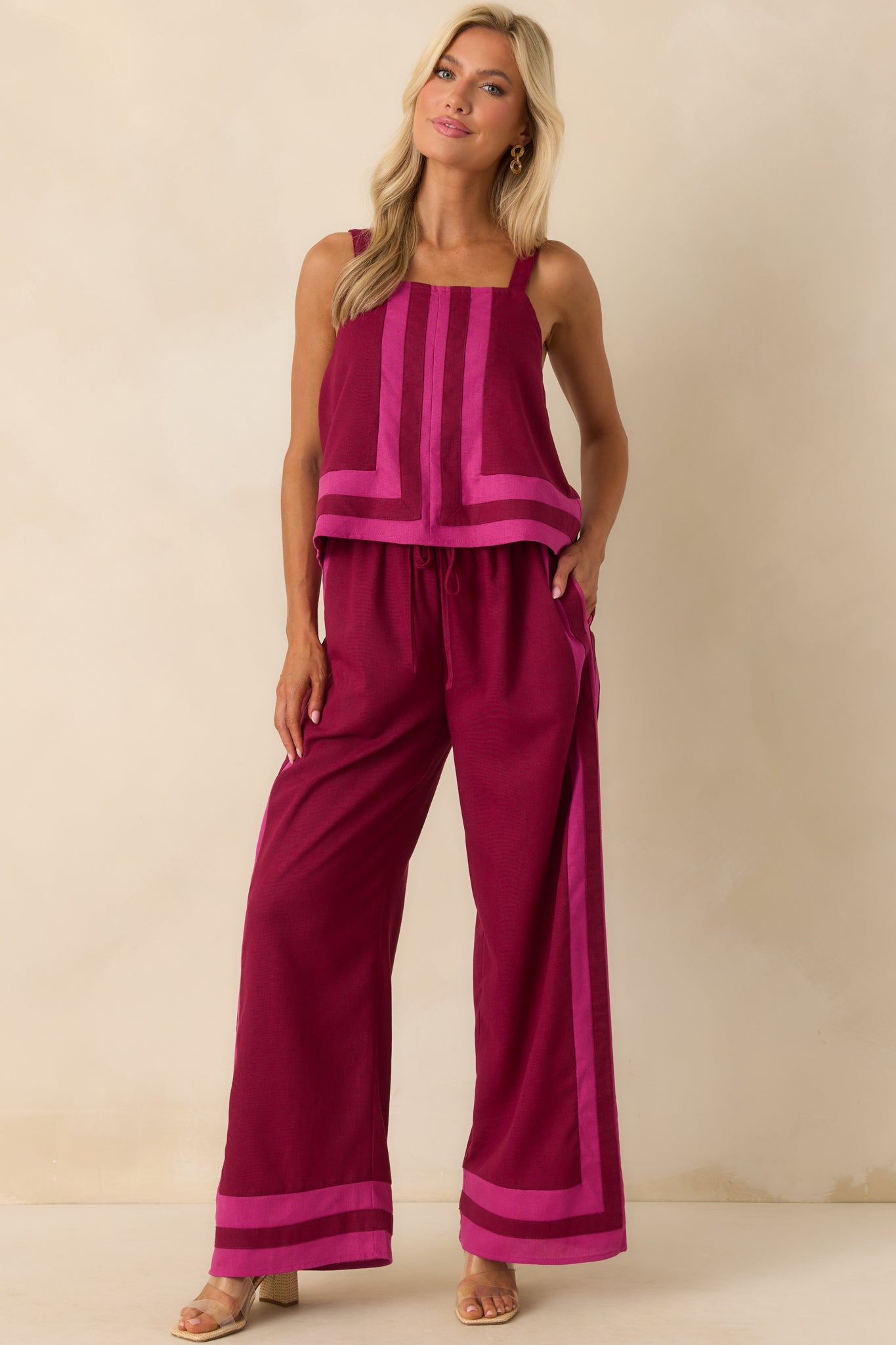 Full front-facing image of the berry pants featuring pink trim accents and a comfortable, high-rise silhouette.