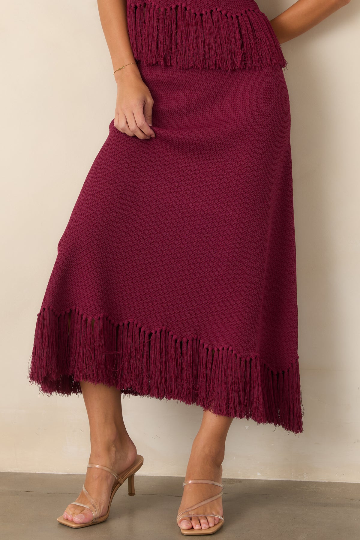 Berry textured skirt featuring a narrow hip-skimming shape and gently expanding hem.