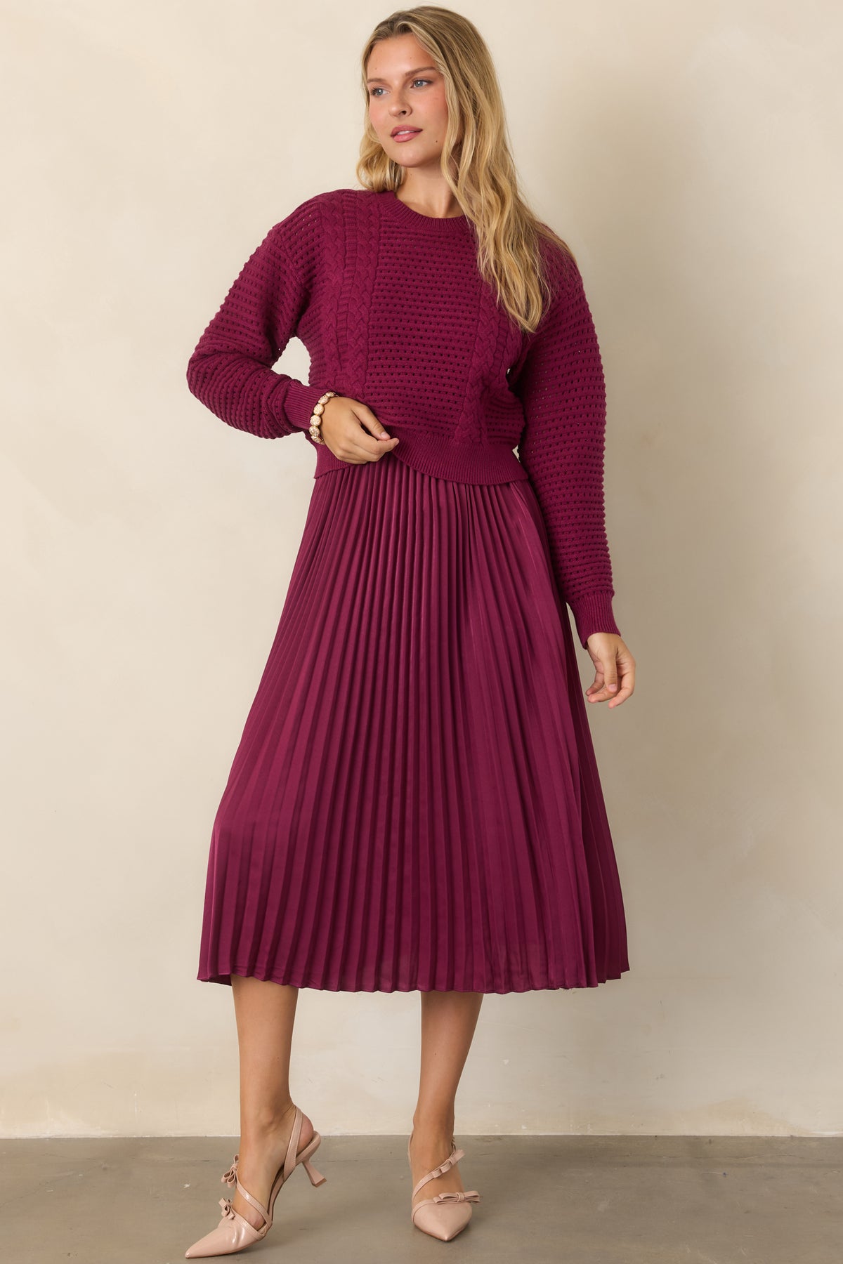 Berry two-piece outfit with a ribbed crewneck sweater and sleeveless satin midi dress.