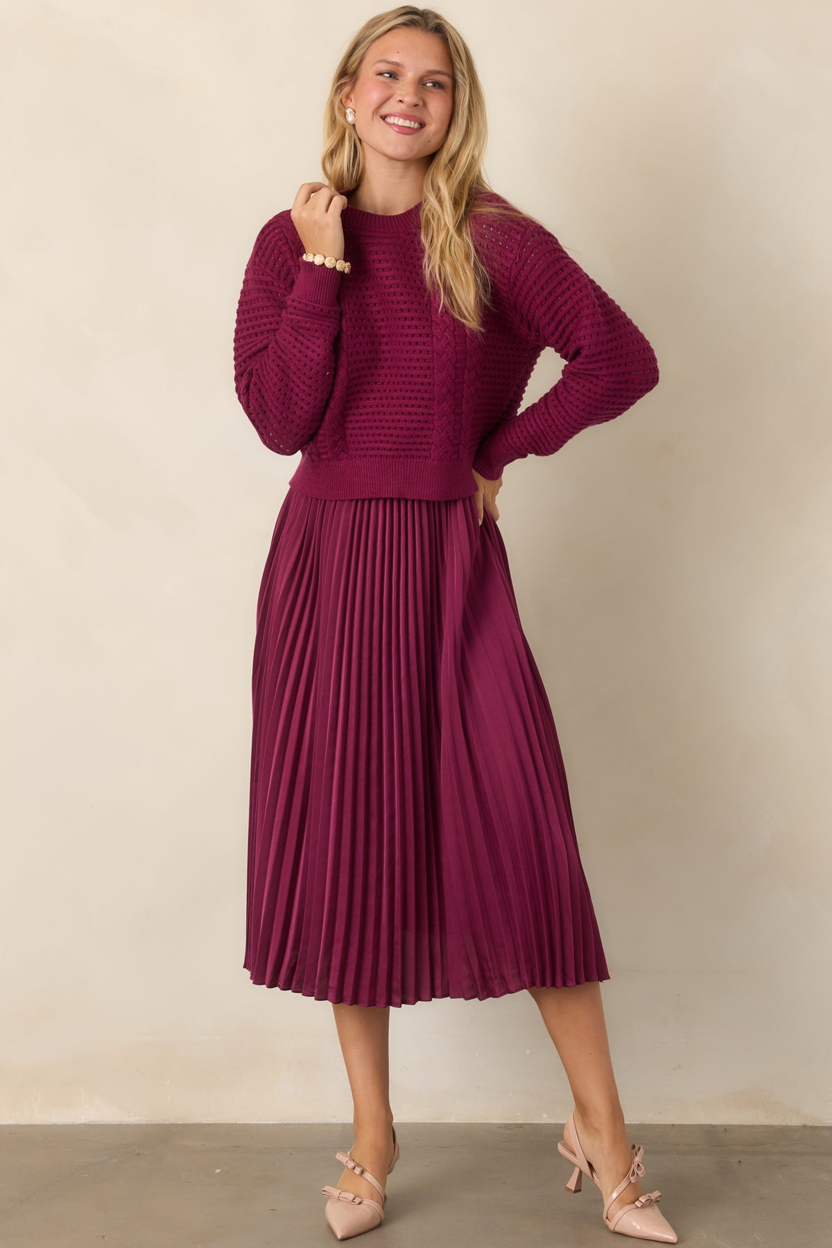 Berry two-piece set featuring an open knit sweater over a sleeveless satin midi dress.