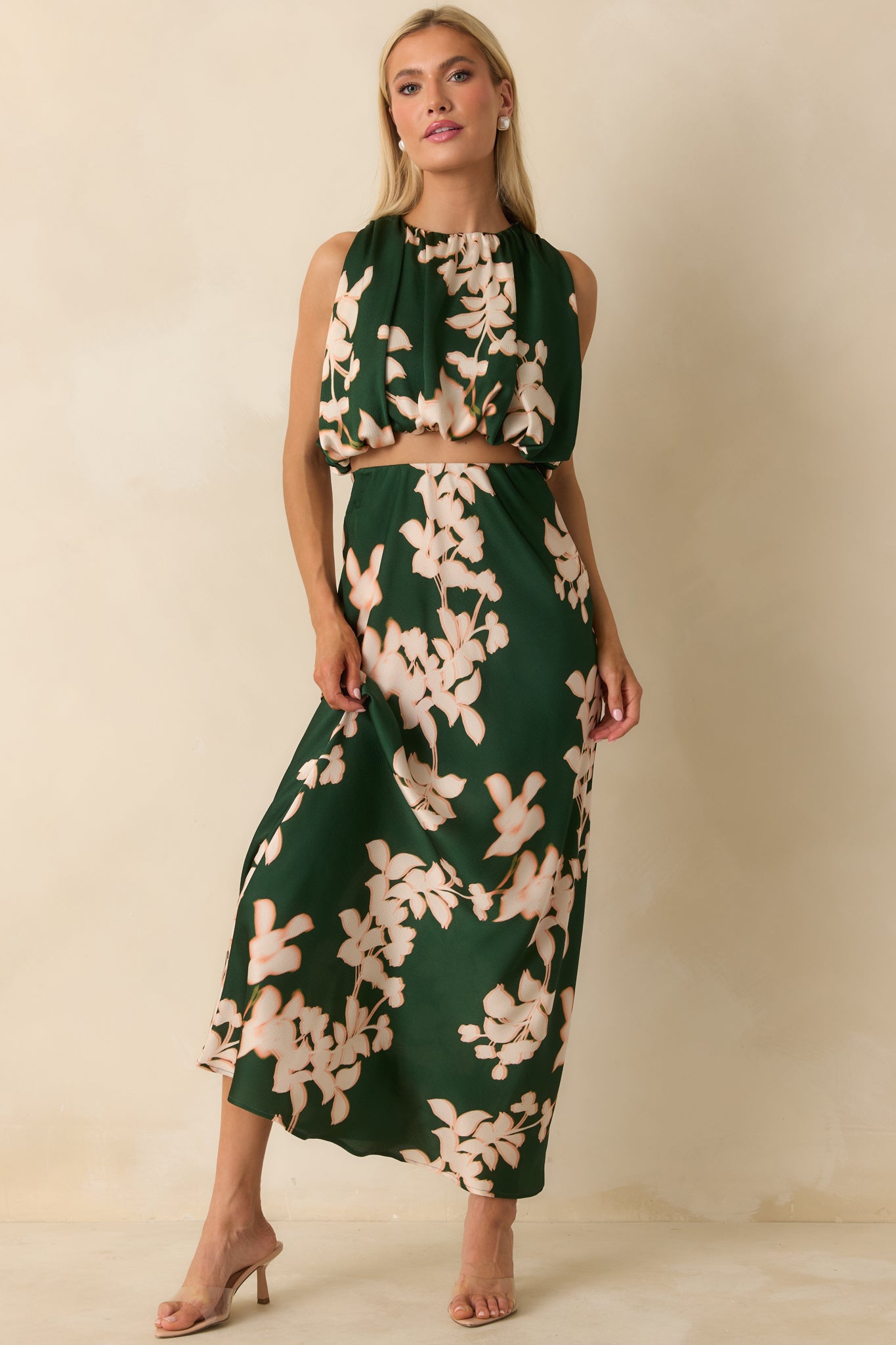 The bias-cut maxi skirt displays a fluid silhouette with full lining and soft floral print.
