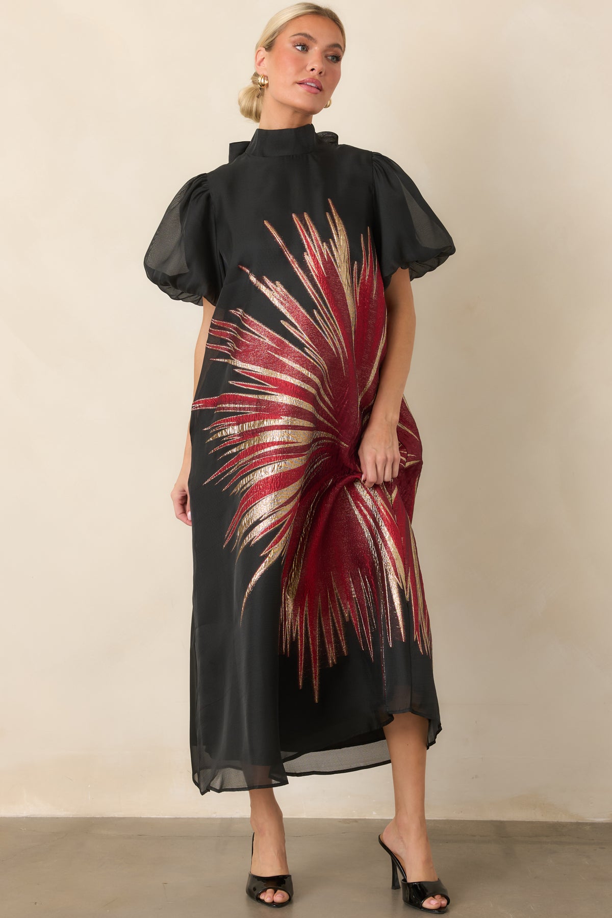 Black A-line midi dress with a striking metallic starburst pattern, sheer puff sleeves, and a relaxed flowing silhouette.