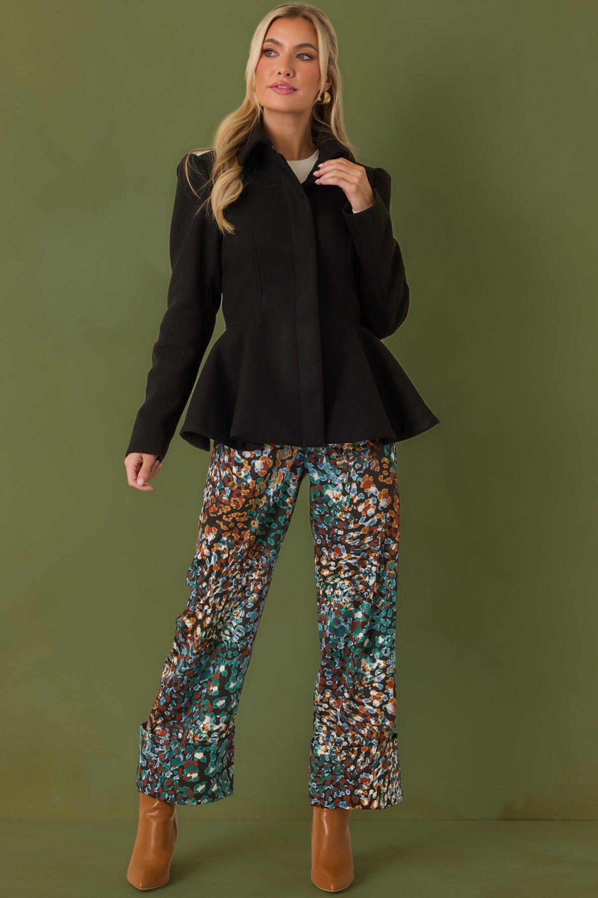 Black cropped pants featuring a rich green, blue, rust, and ivory abstract animal print.