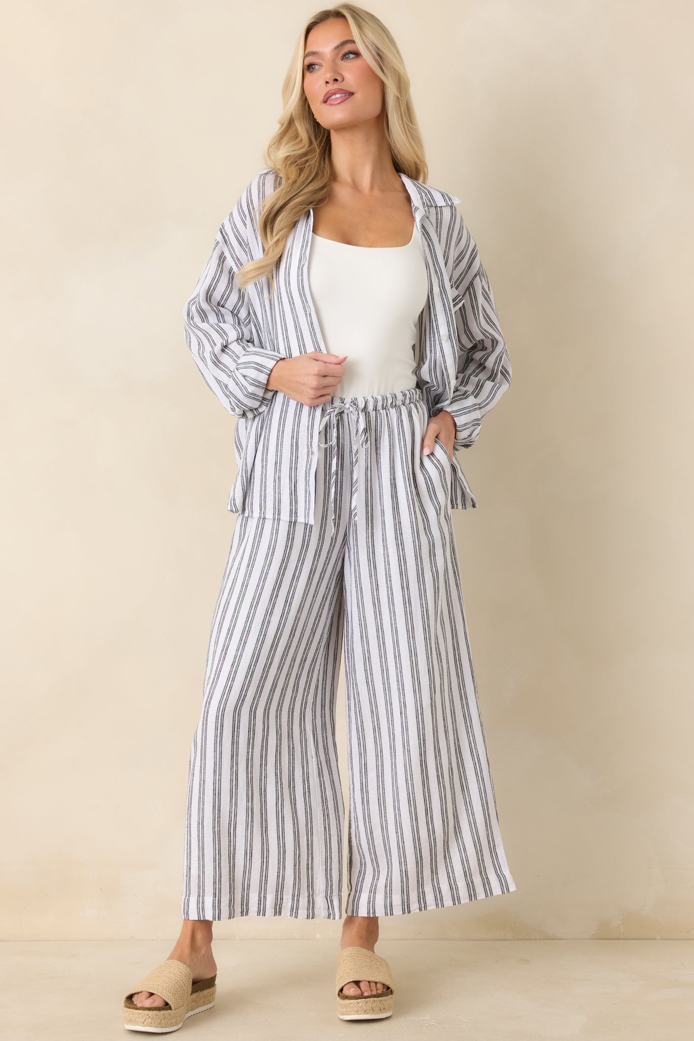 Black and white stripe top with chest pocket, full button front, and laid-back fit.