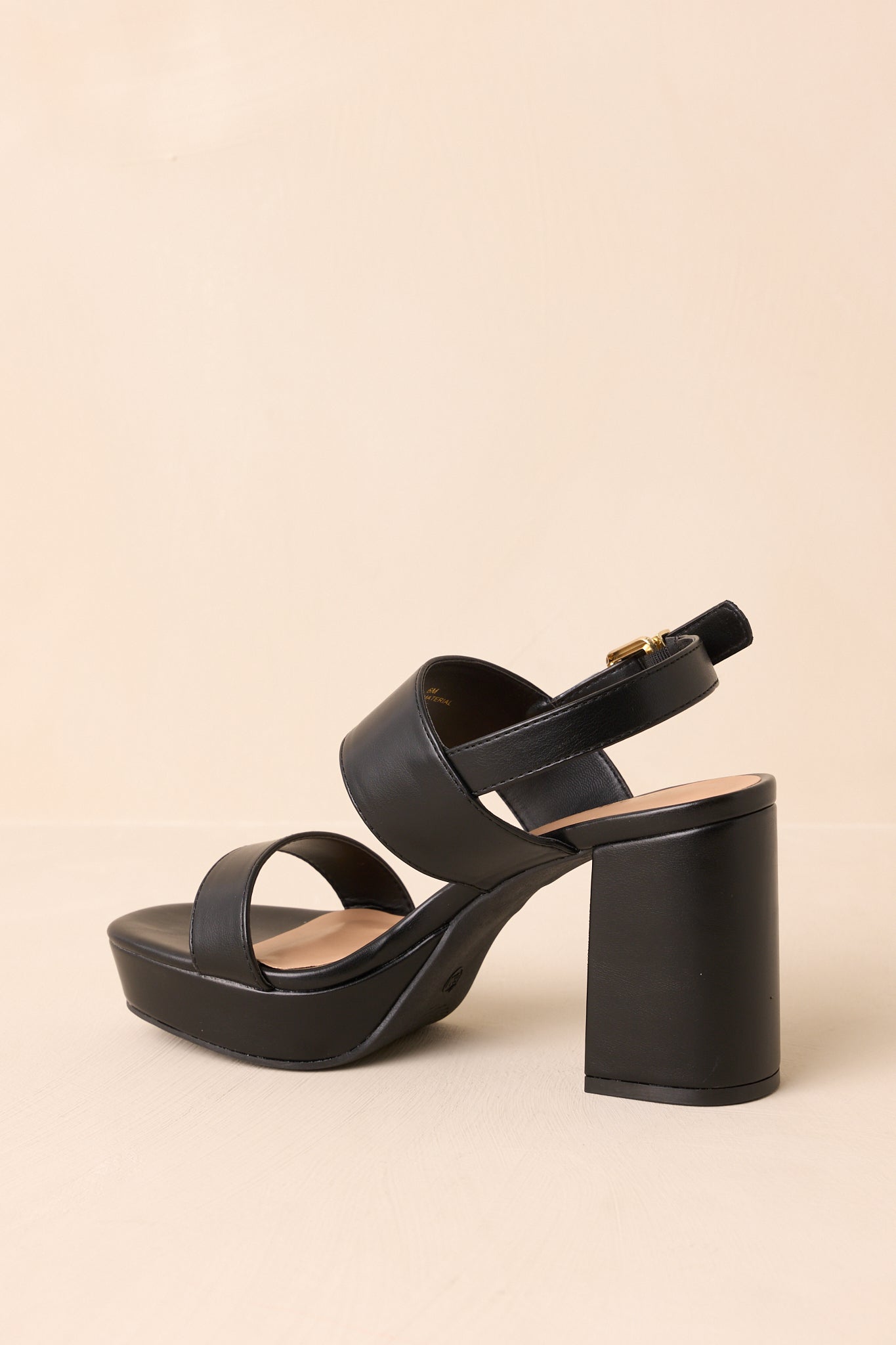 Rear view of the black block heel sandals highlighting the back ankle strap and heel shape.
