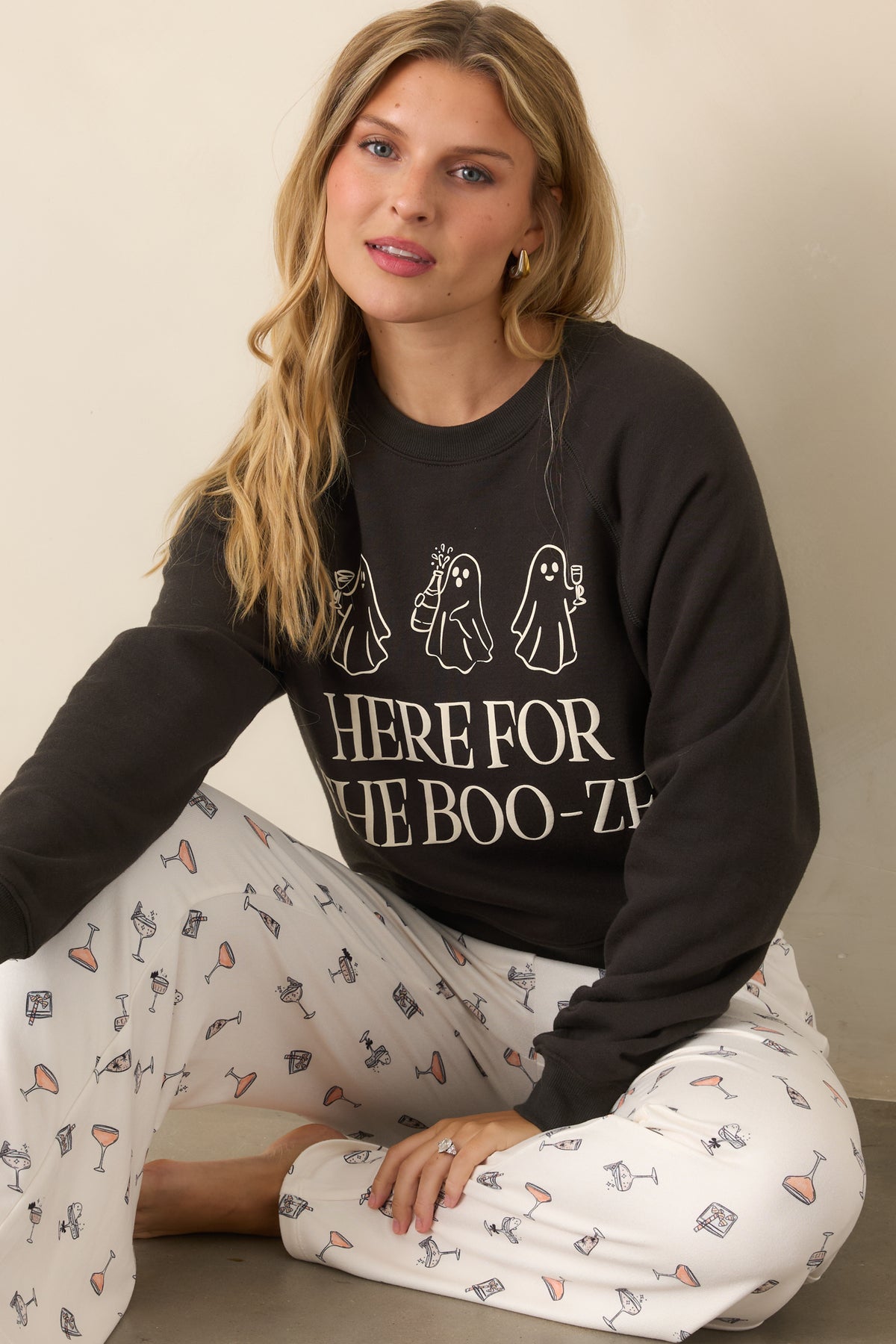 Cotton-blend black sweatshirt showcasing the ghost cocktail graphics, oversized front lettering, and ribbed crew neckline.