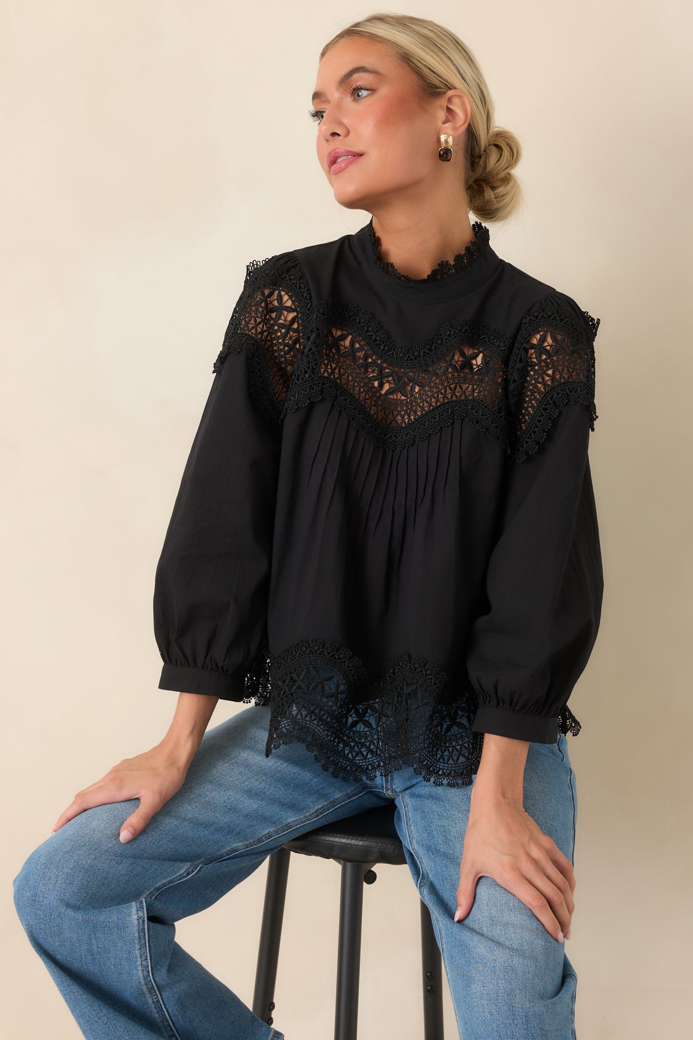 Black cotton blouse featuring a lace-trimmed high neckline, scalloped openwork yoke, and three-quarter balloon sleeves.