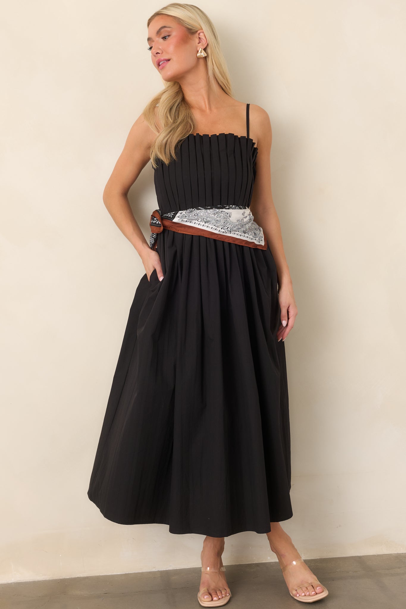 Black 100% cotton midi dress featuring adjustable spaghetti straps, a square neckline, pleated fitted bodice, and full gathered skirt.
