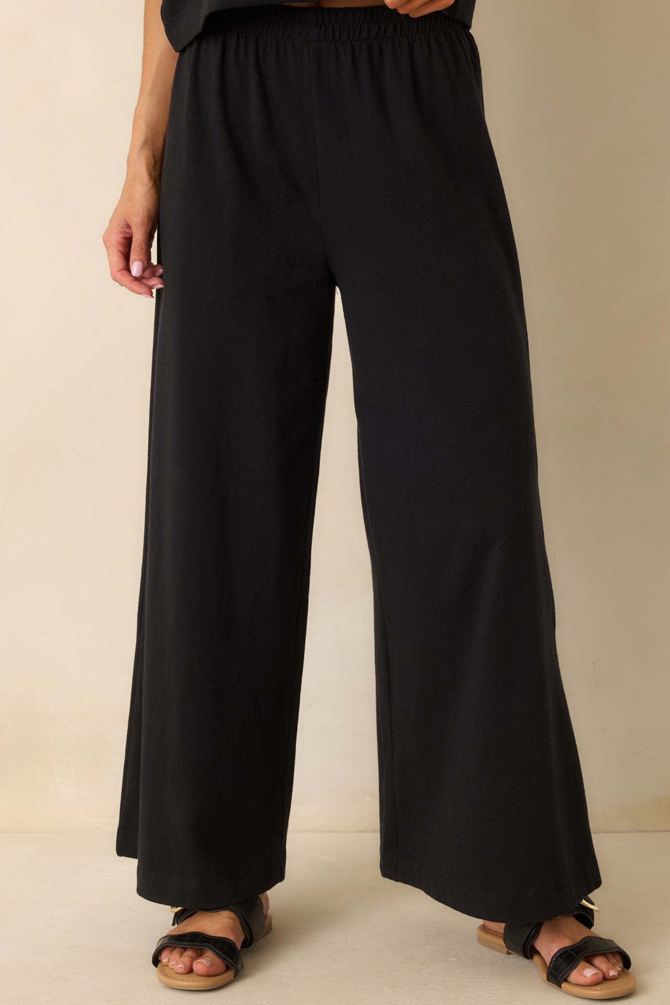 A cropped image of the lower pant legs showing the wide cut and fluid movement of the fabric.