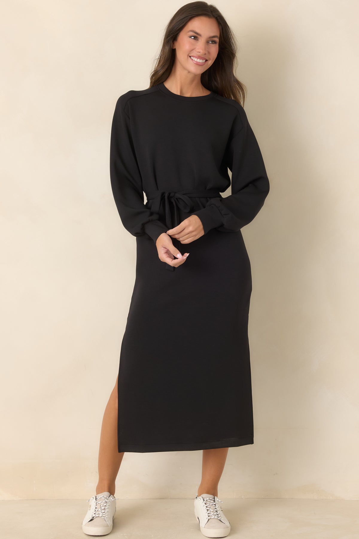 Black casual midi dress with a crew neckline, long sleeves, and matching waist tie.