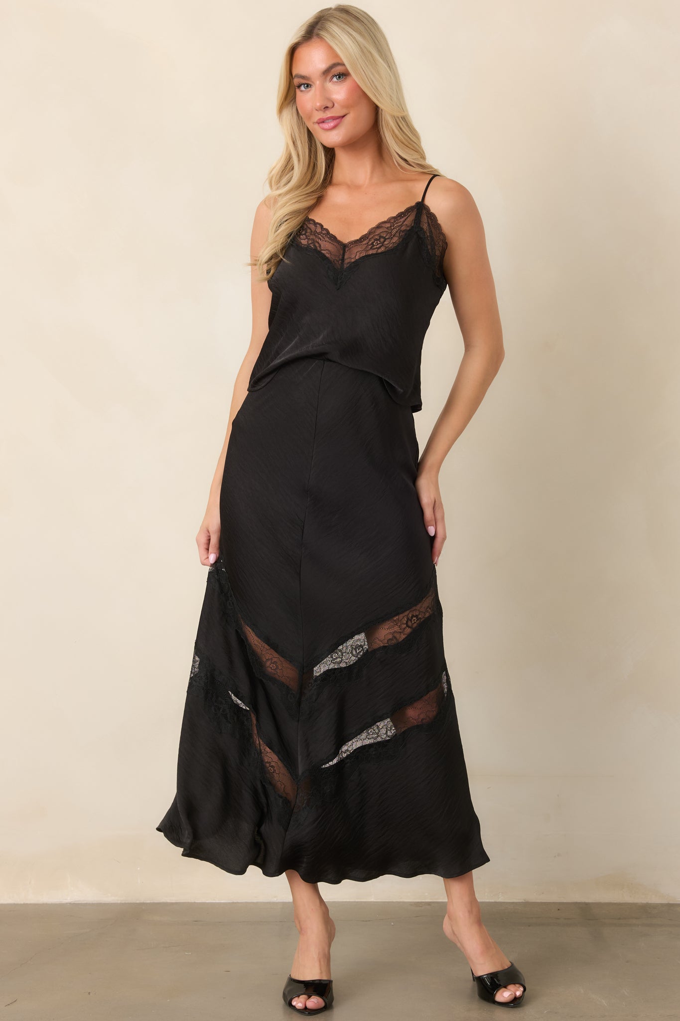 Black crinkled satin top with delicate lace trim framing the V-neckline and relaxed shape.