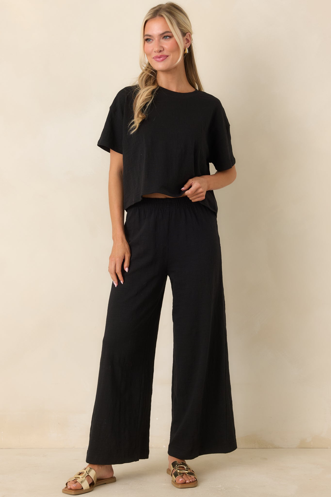 Front view of black cropped top showcasing lightweight fabric and relaxed, modern shape.