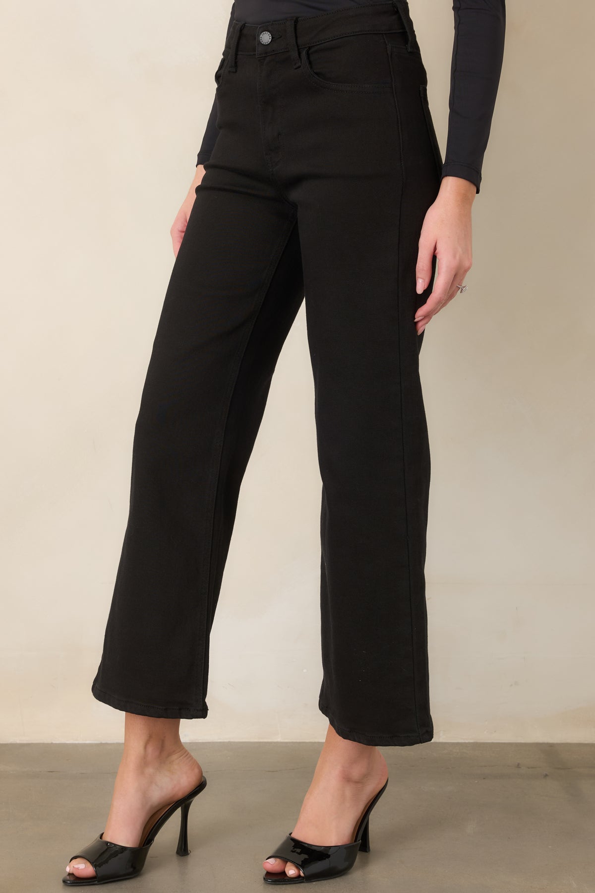 Black cropped jeans with a wide-leg shape, high-rise waist, belt loops, and clean waistband construction.