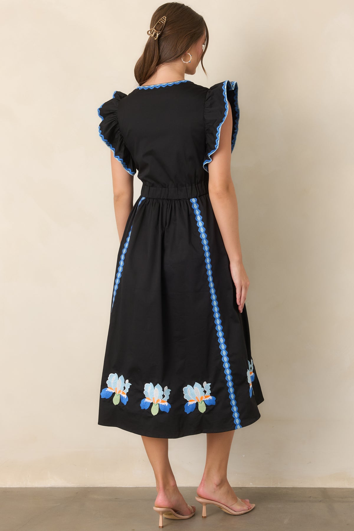 Rear of the black dress showing the gathered A-line skirt and elasticized waist.