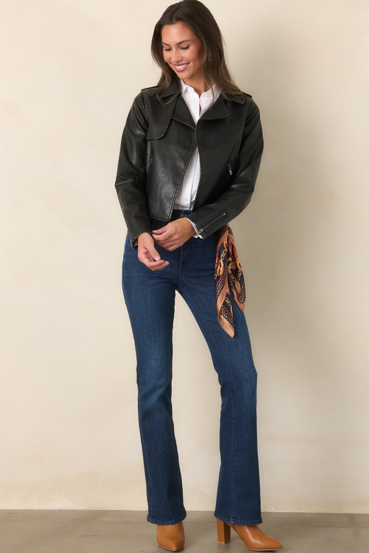 Black faux leather jacket with an open front, wide notched lapels, long sleeves, and a cropped silhouette.