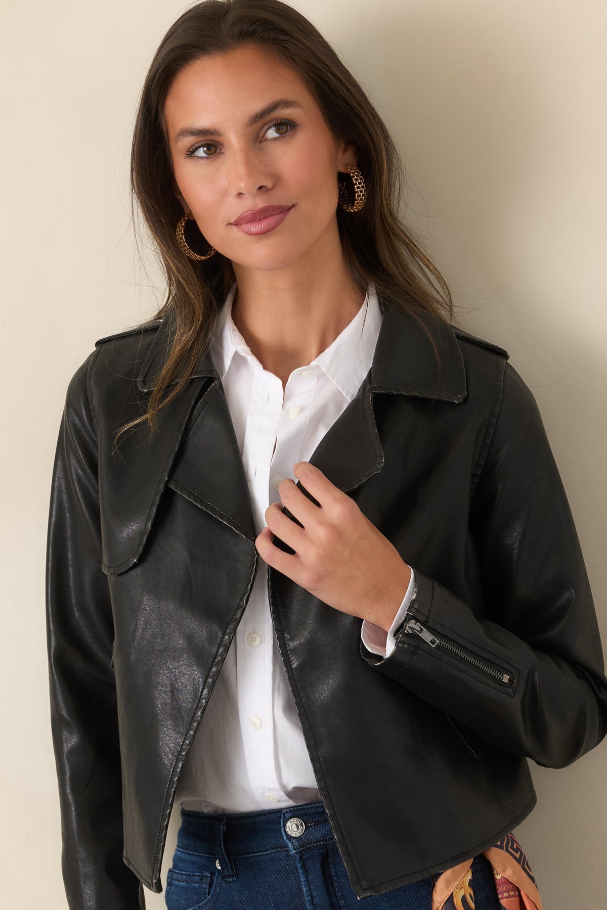 Black faux leather jacket with wide notched lapels and an open front.