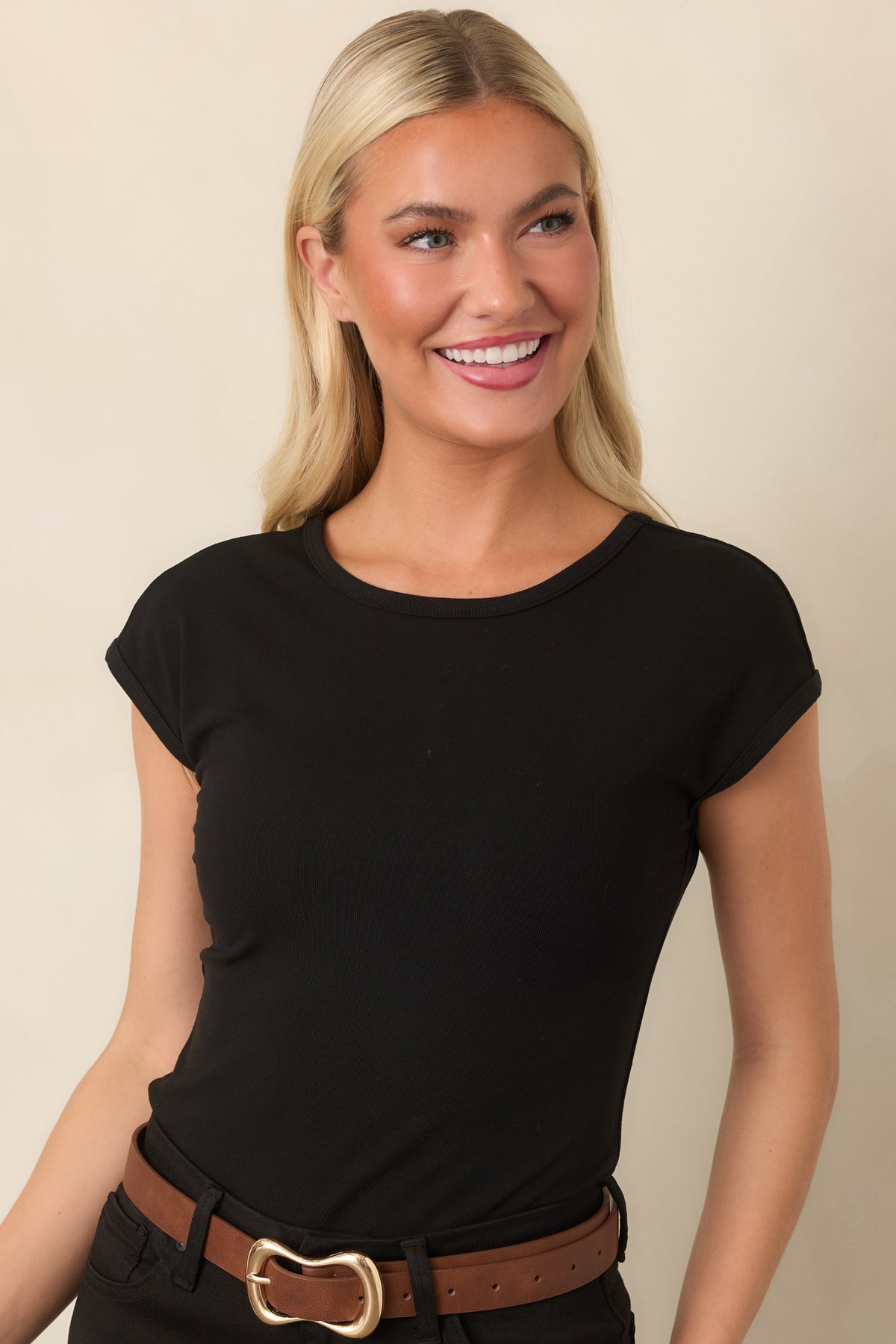 Black fitted top showcasing the clean crew neckline and cap sleeves.