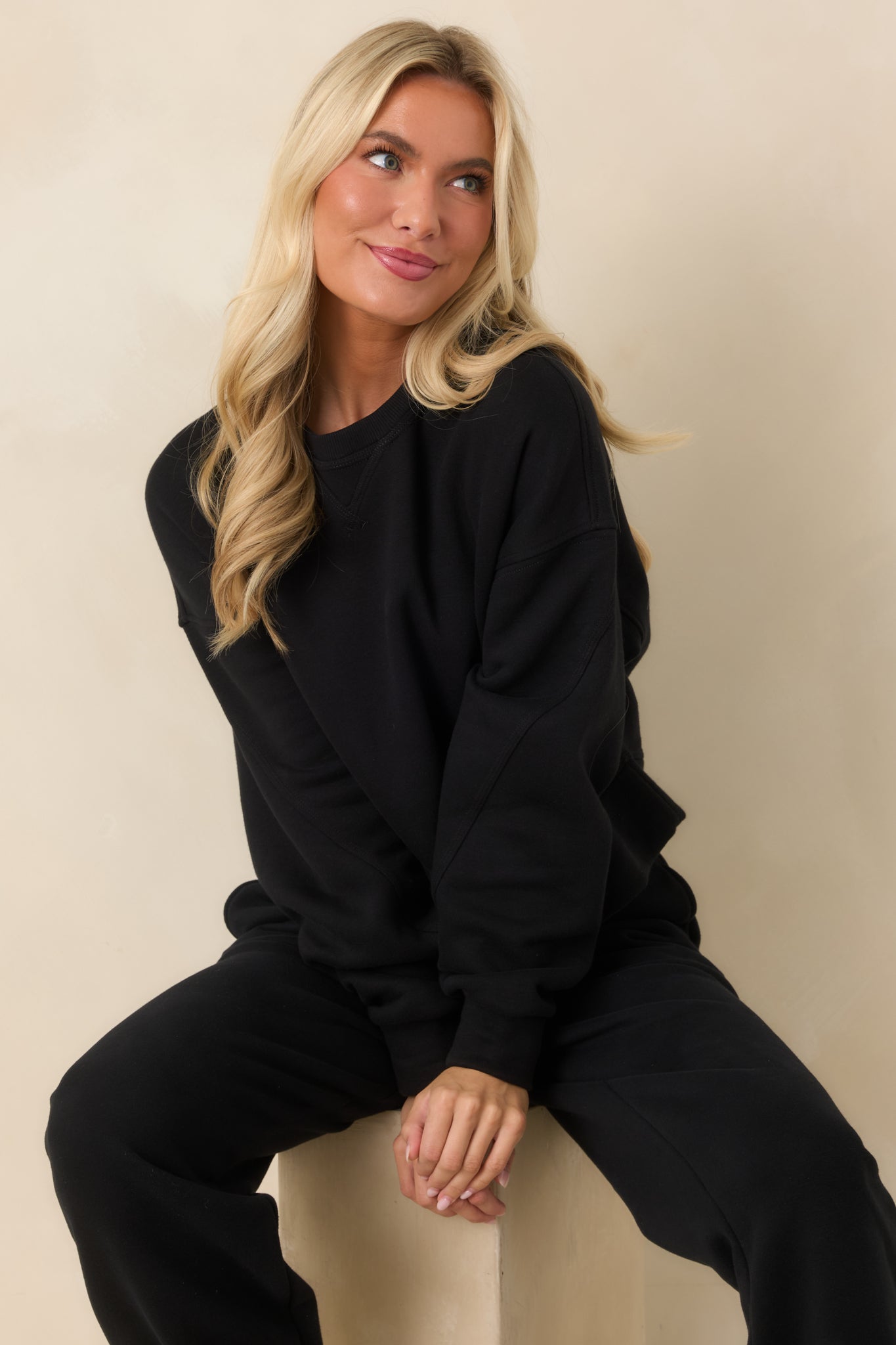 Black cotton-blend fleece sweatshirt featuring a ribbed crew neckline, dropped shoulders, long sleeves, and a slightly cropped silhouette.