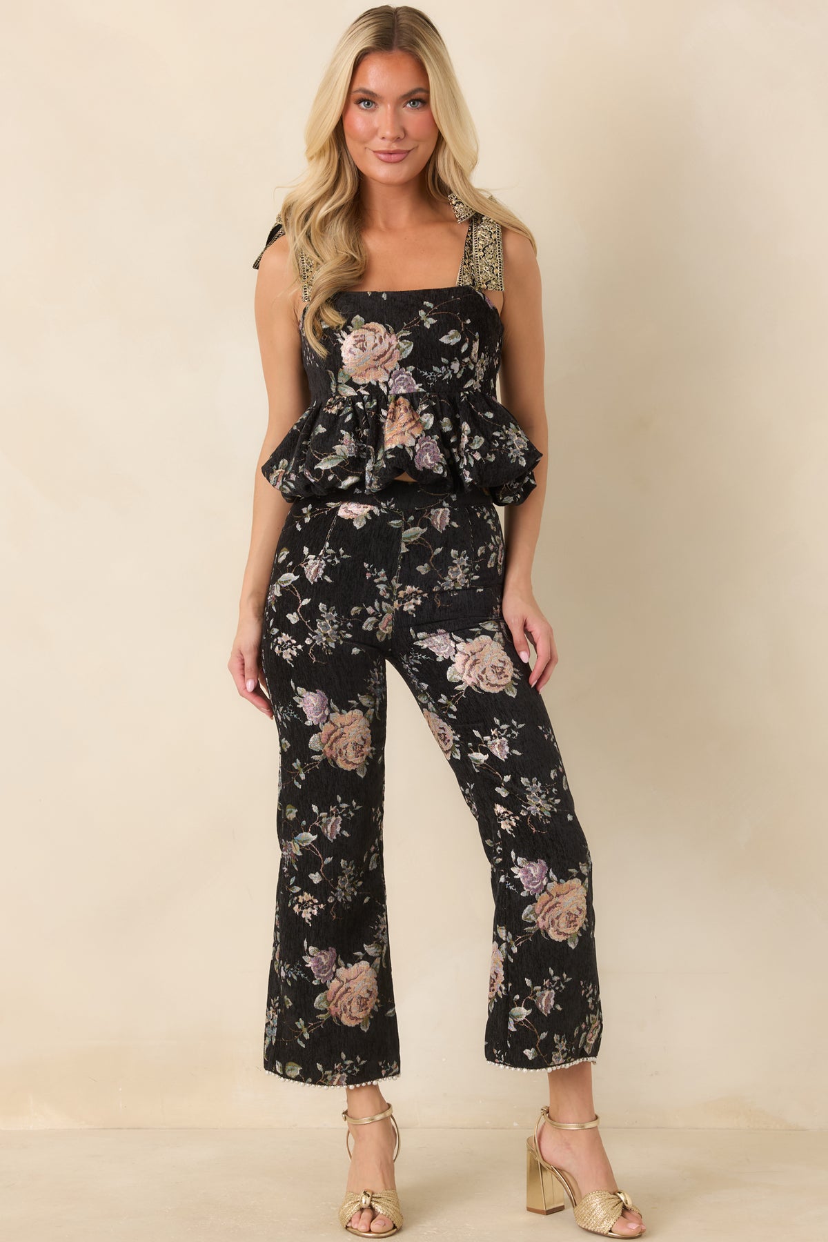 Textured black floral top featuring a straight neckline, fitted bodice, and embroidered shoulder ties.