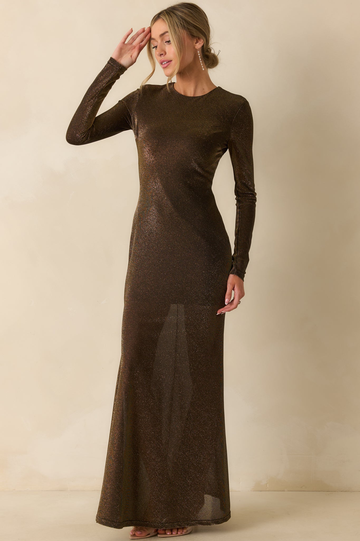 Stretchy black and gold maxi dress with a semi-sheer shimmer overlay enhancing the smooth, fitted design.