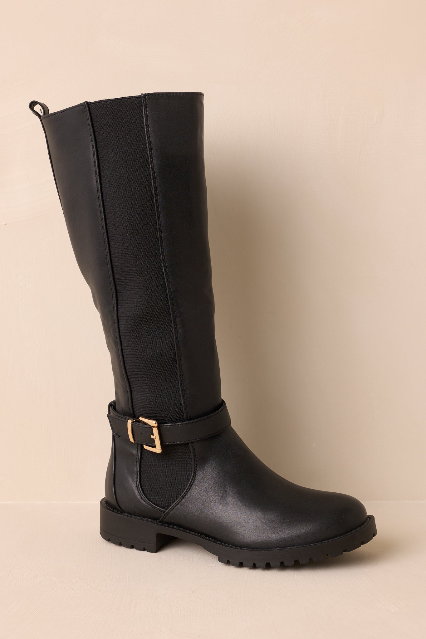 Front view of black knee-high boot displaying round toe, low block heel, and smooth faux leather.