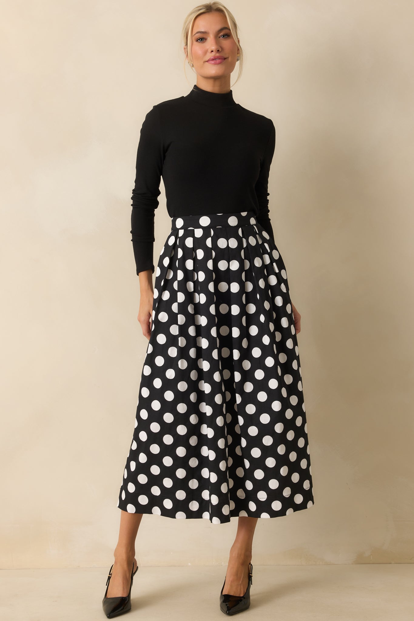 Long sleeve black turtleneck top showing its smooth lightweight fabric.