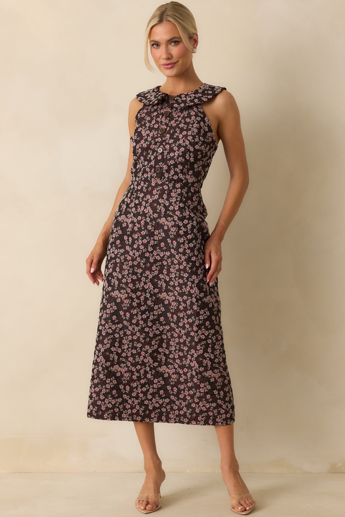Midi dress with a black base and pink floral jacquard, featuring a collared neckline and sleeveless structured fit.