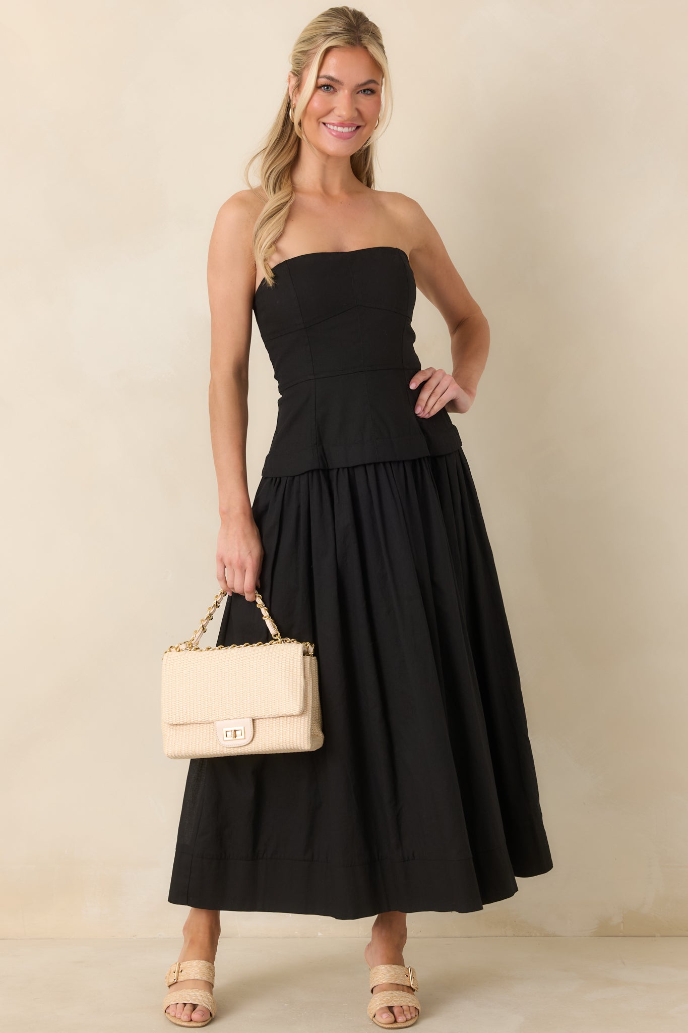 Black midi dress with a defined waist, paneled bustier top, and smooth full lining creating a polished finish.