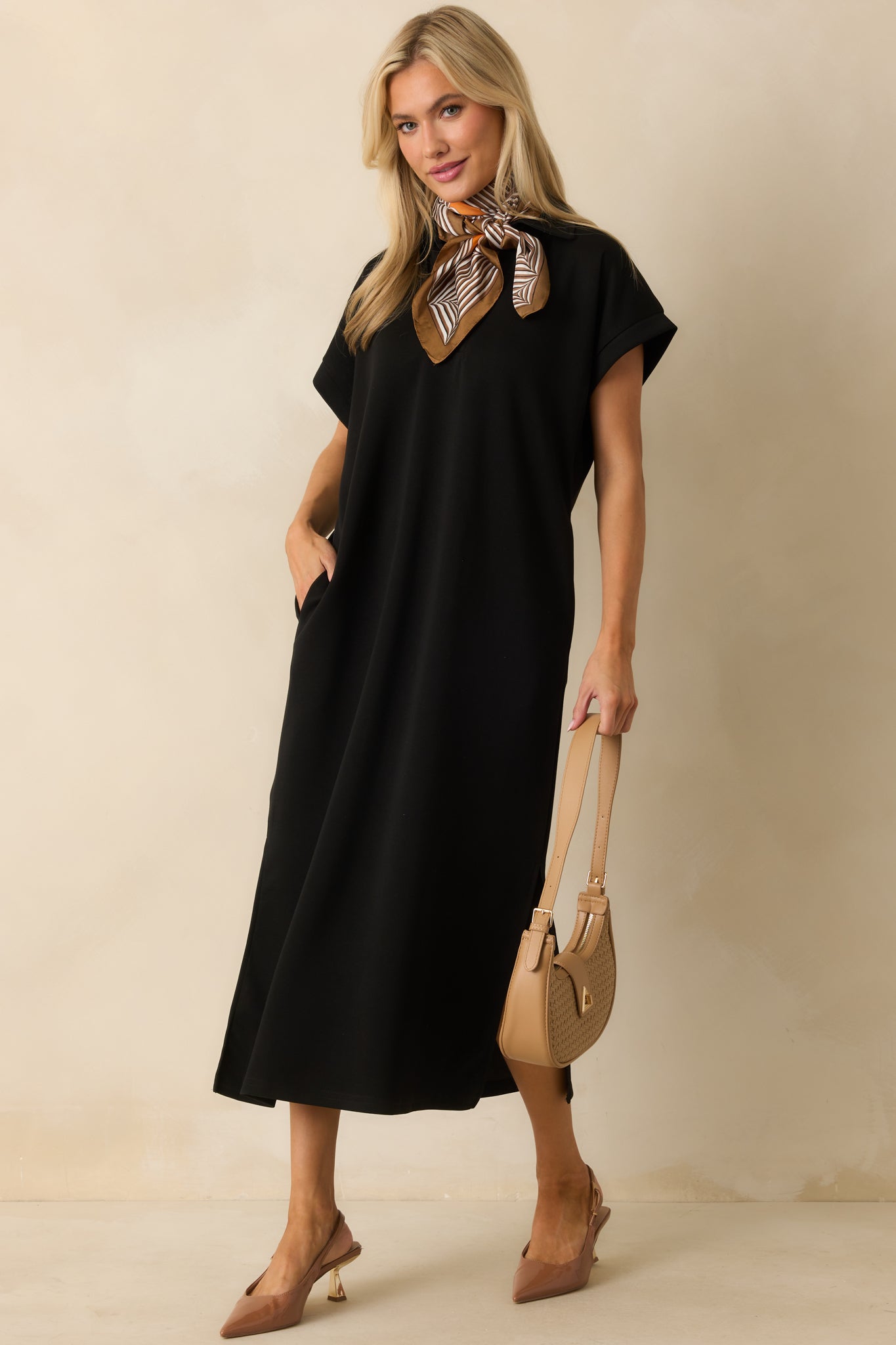 Black midi dress with a collared notch v-neckline and short sleeves.