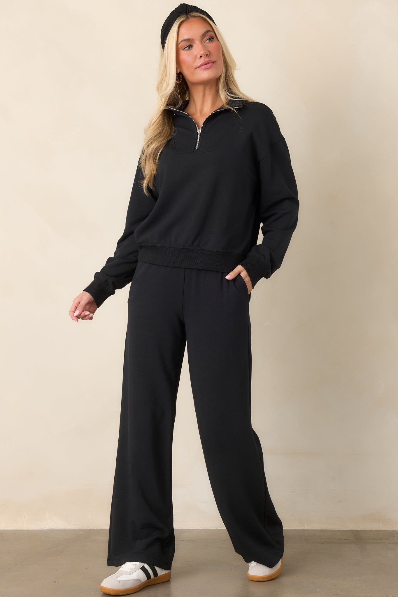 Black modal-blend sweatshirt with a stand collar, half-zip neckline, dropped shoulders, long sleeves, and ribbed cuffs and hem.
