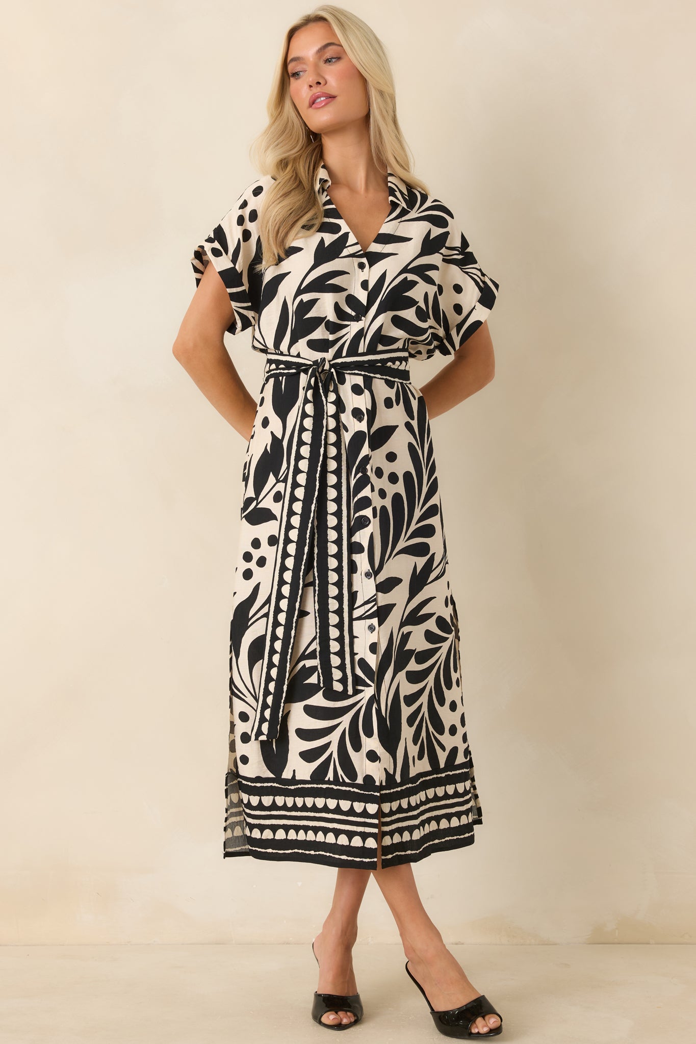 Black and natural printed midi dress designed with a flattering waist tie, side slits, and polished everyday style.