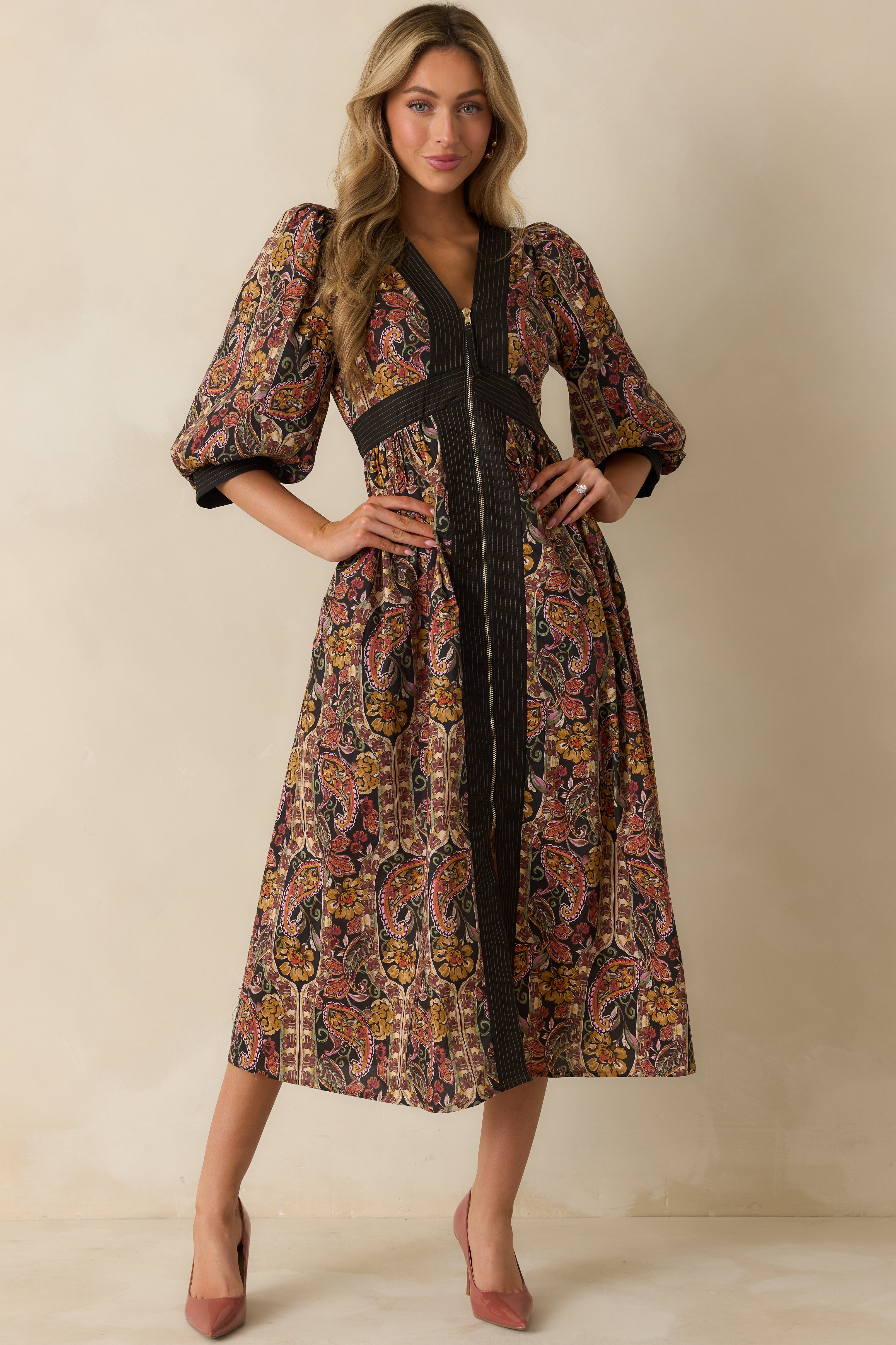 Black paisley floral maxi dress with deep V-neckline, half puff sleeves, and flowy A-line skirt.