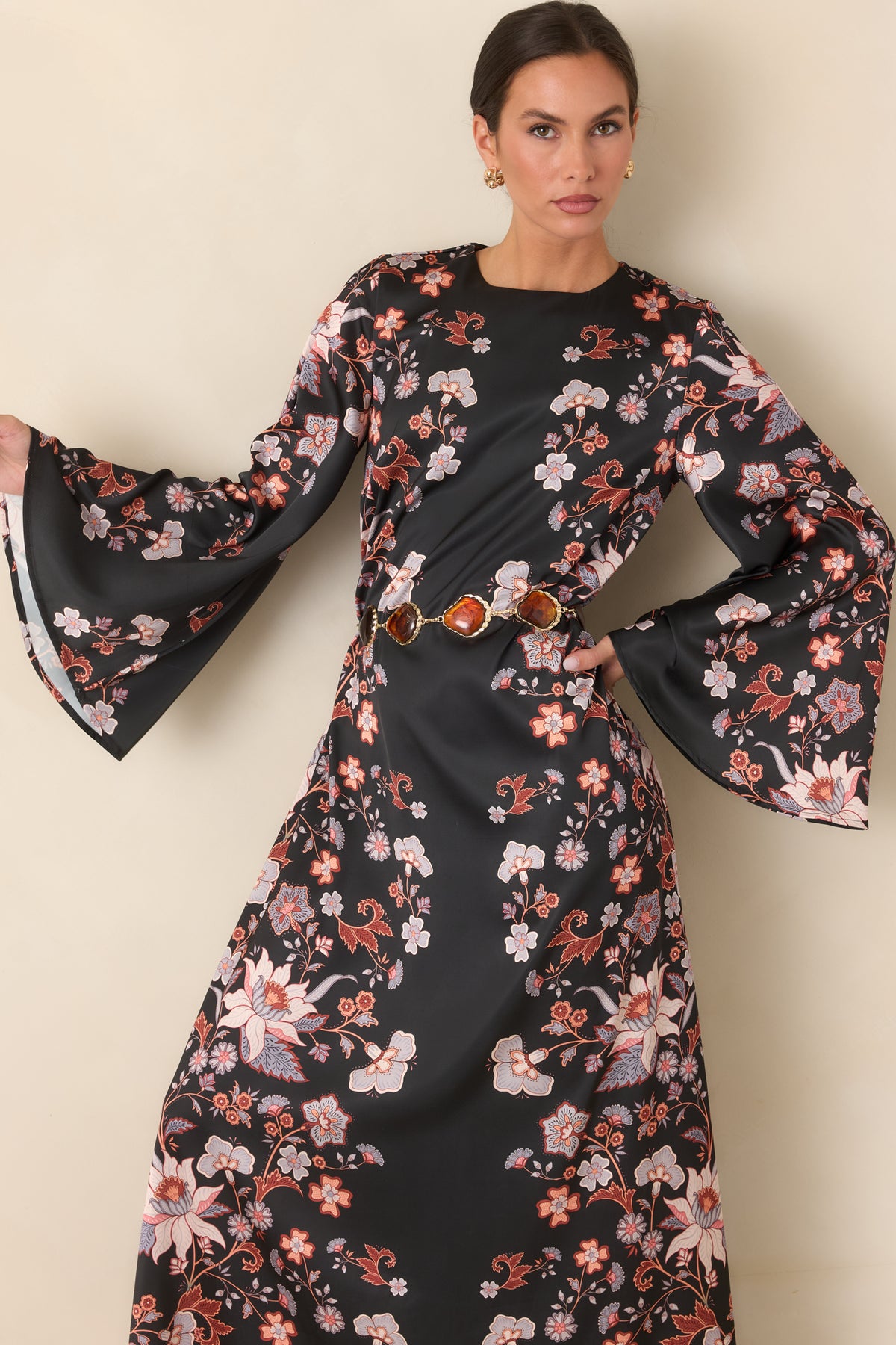 Black satin maxi dress featuring blush, ivory, rust, and muted blue floral accents.