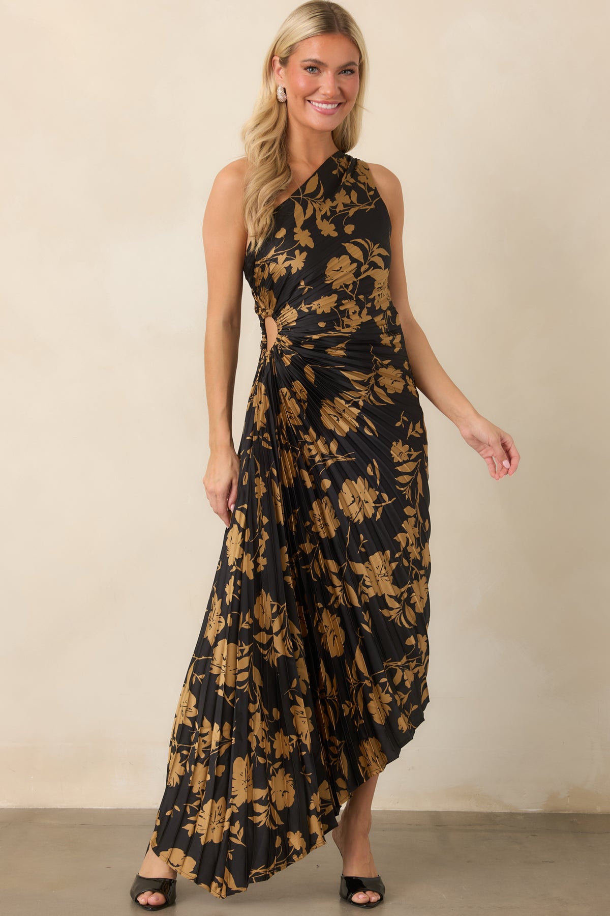 Black satin creates a sleek foundation for the golden floral print and asymmetrical skirt with graceful movement.