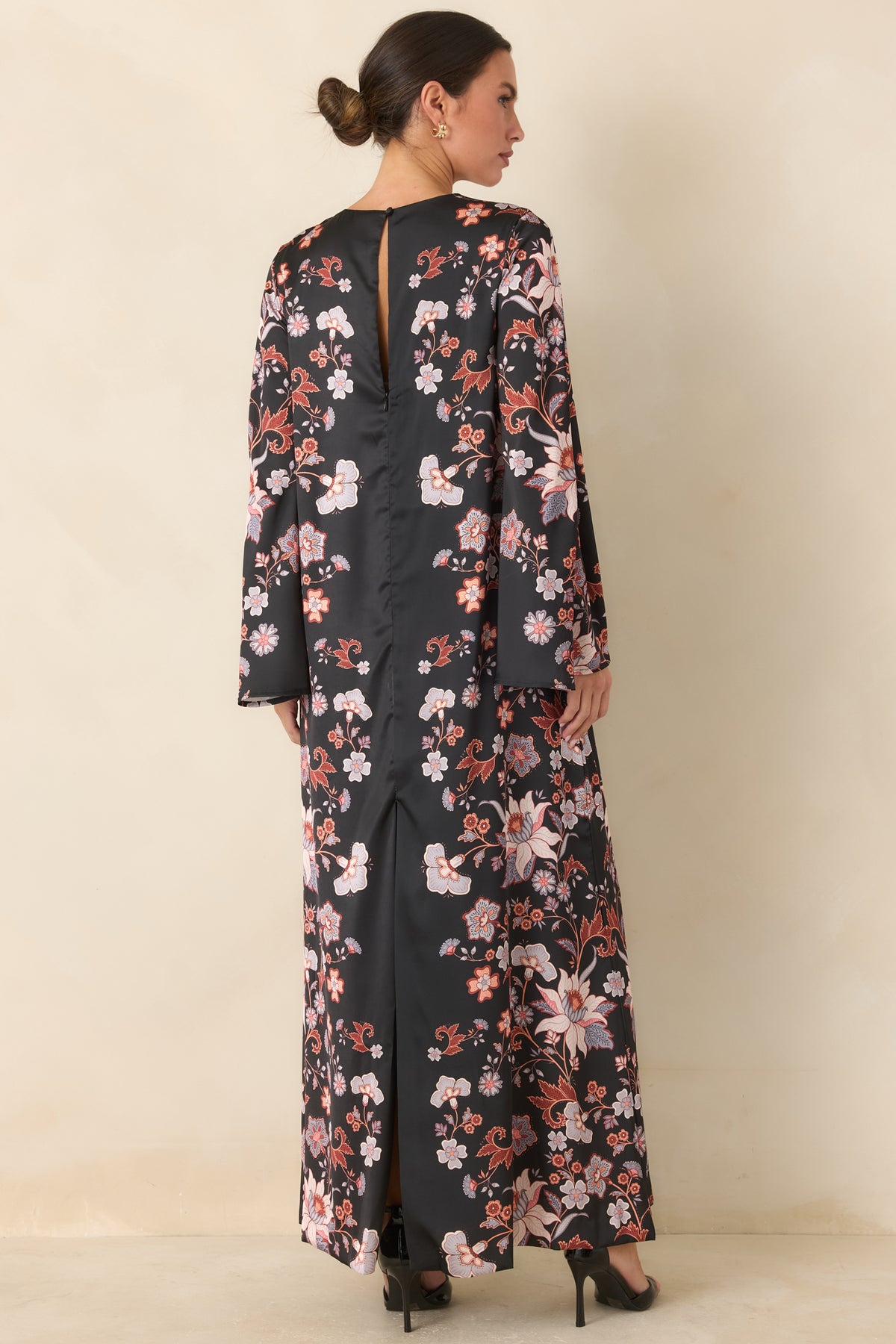 Black satin maxi dress showing the rear keyhole, single button closure, and back slit.