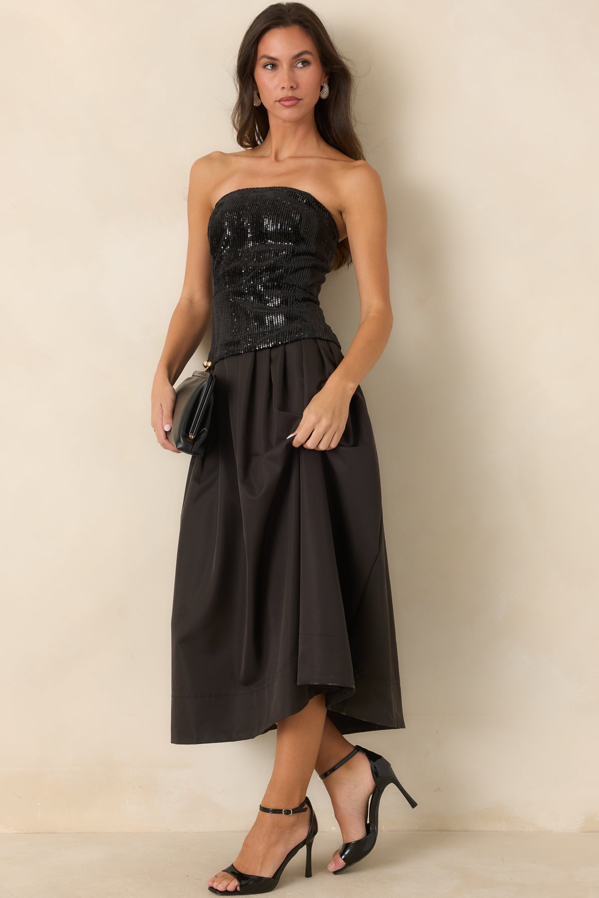 Black sequin bodice dress with a flowing pleated midi-length skirt.